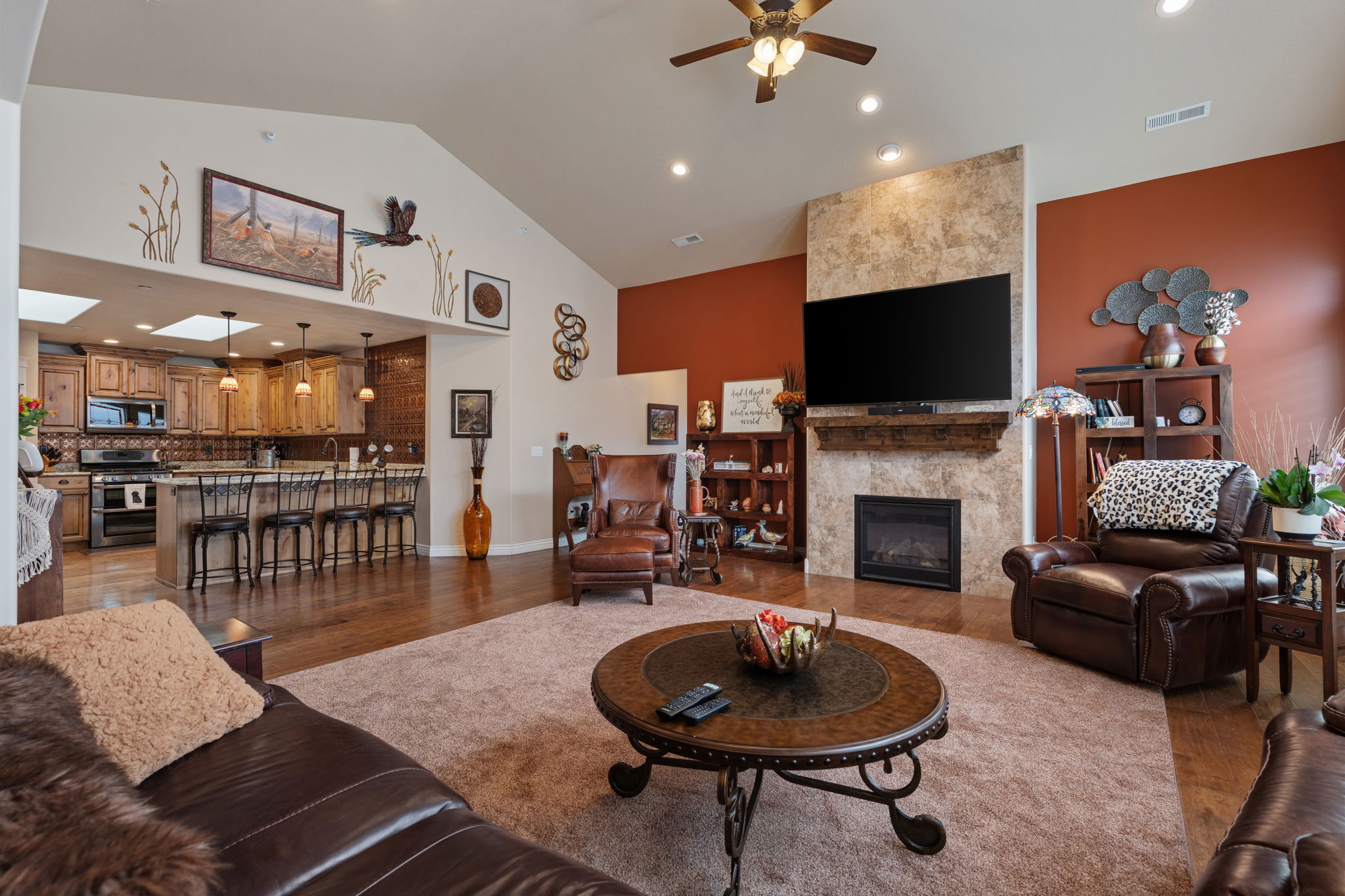 Open-concept living space featuring vaulted ceilings and recessed lighting