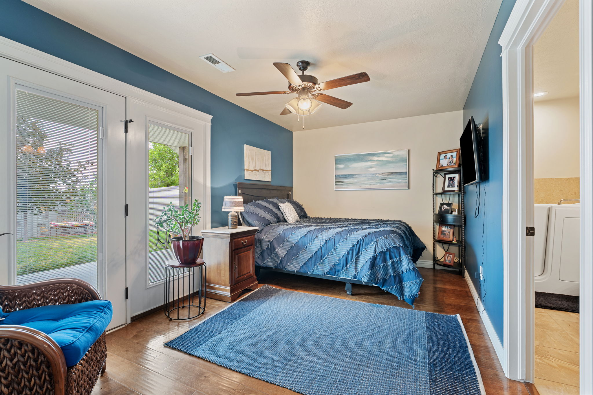 Bedroom featuring hardwood-finish flooring and a ceiling fan with integrated lighting