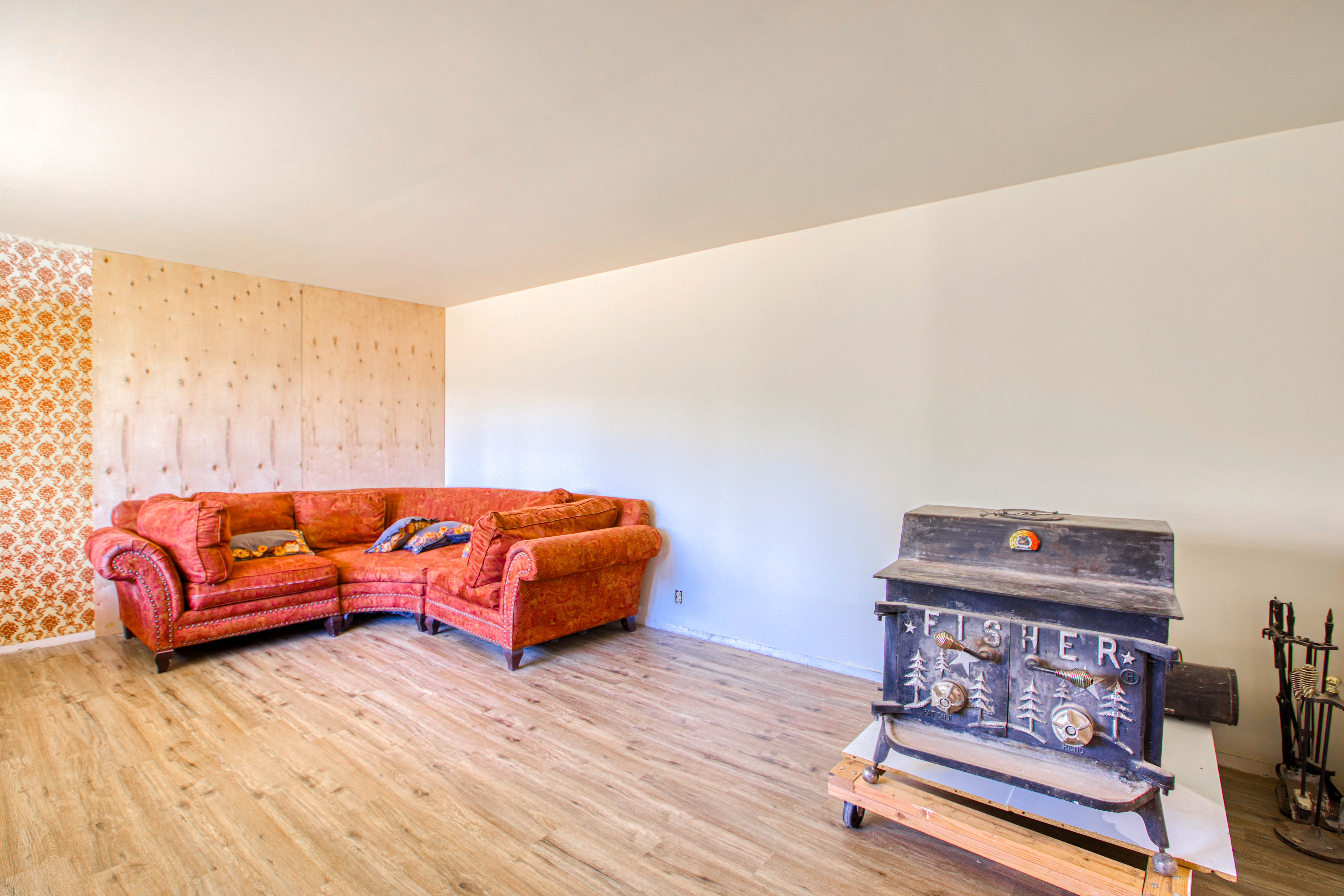 Living area featuring wood-finish flooring and a cast iron wood stove