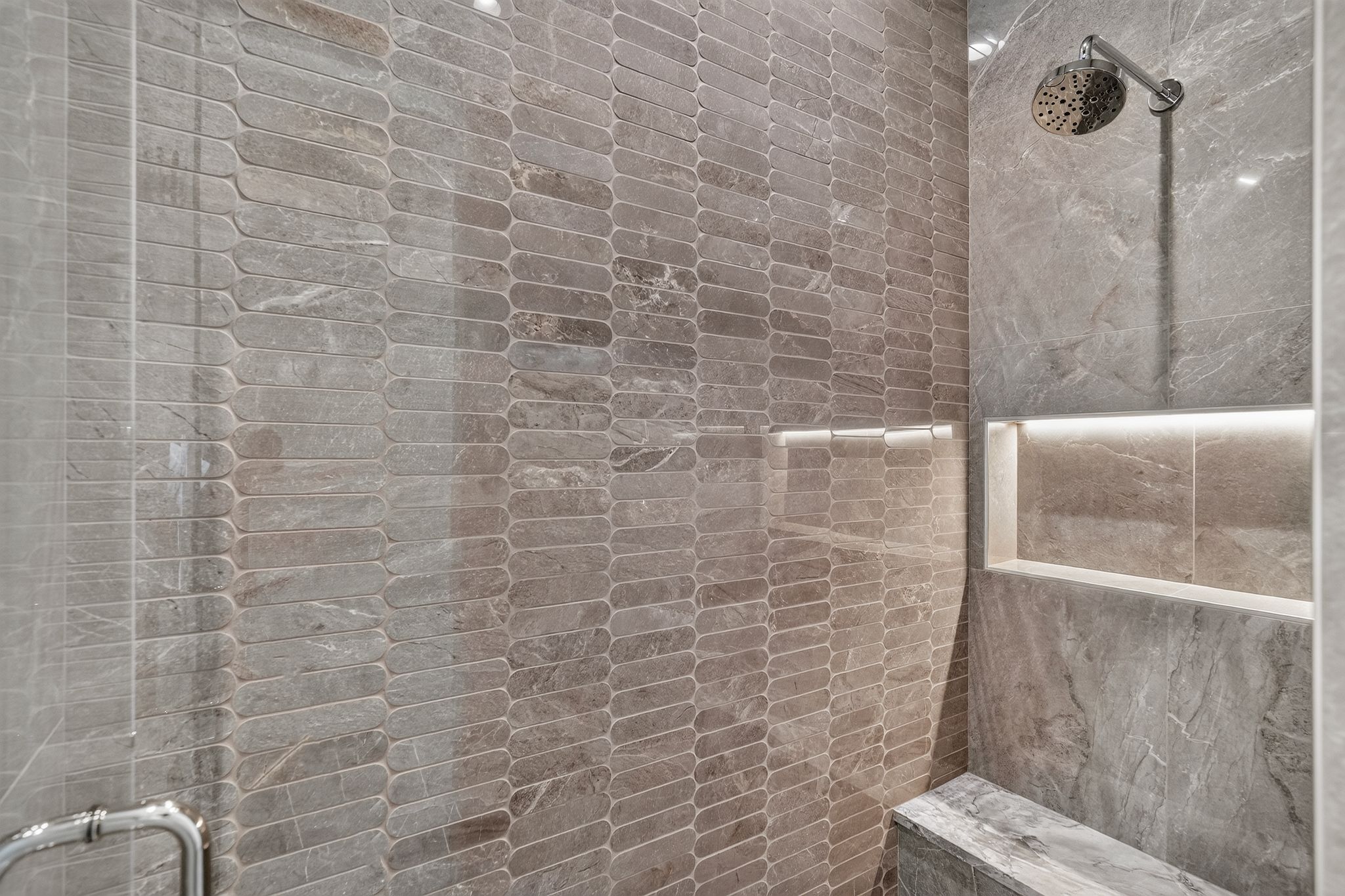 Walk-in shower featuring a rain showerhead, recessed lighting, and a built-in bench