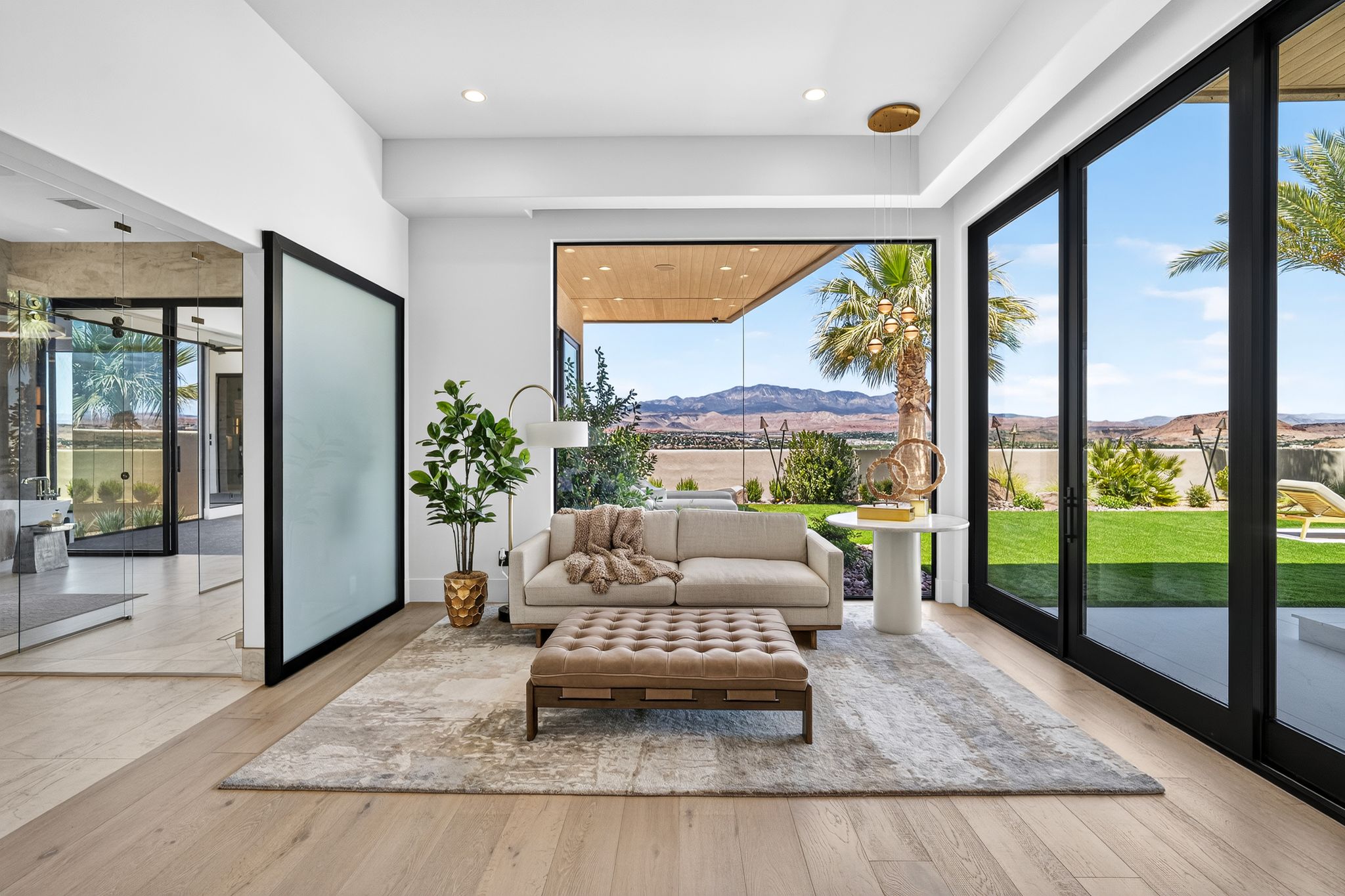 Light wood-finish flooring complements white walls in this living space