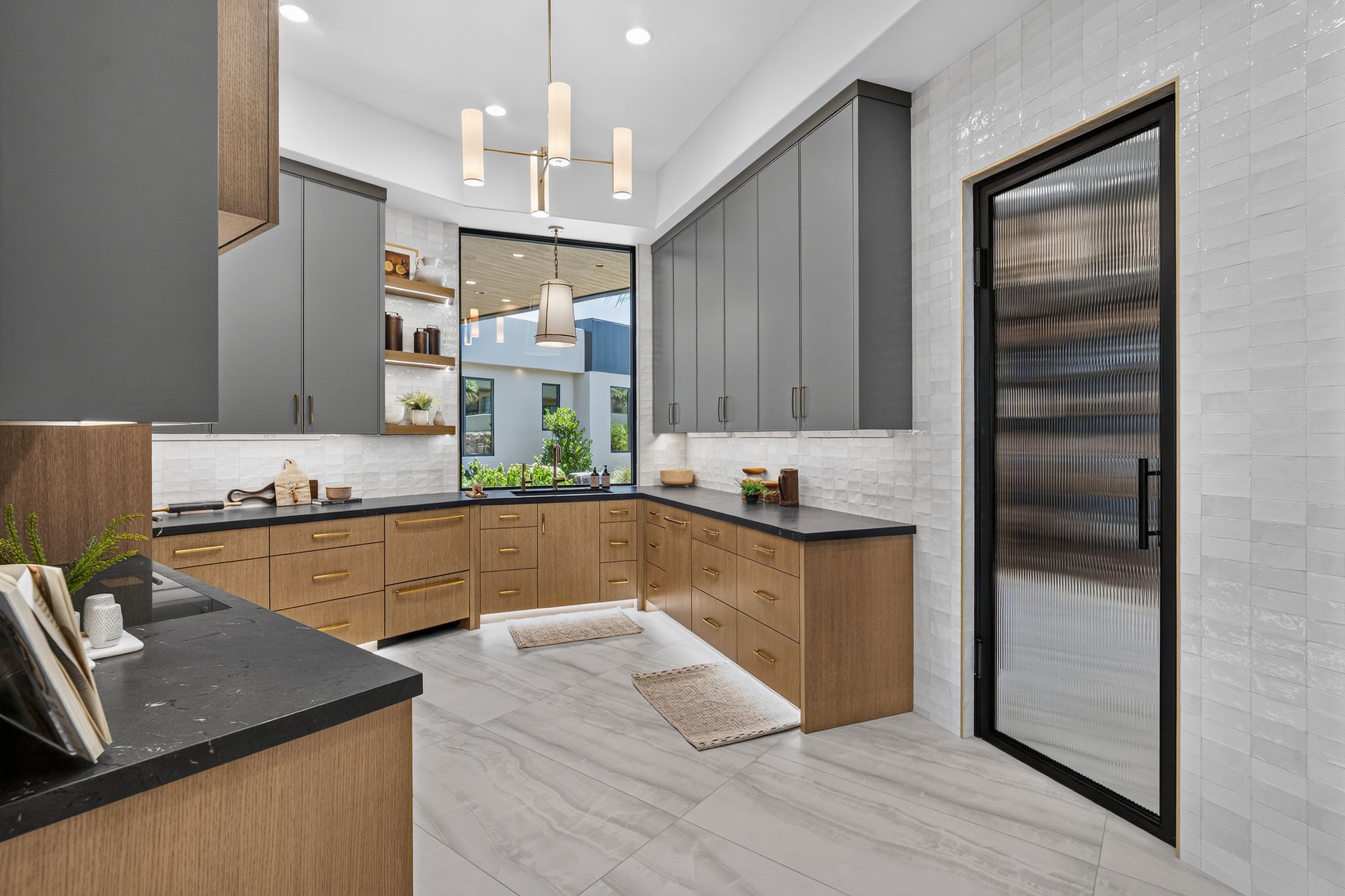 Modern kitchen featuring two-tone cabinetry with matte gray upper cabinets and wood-finish lower cabinets