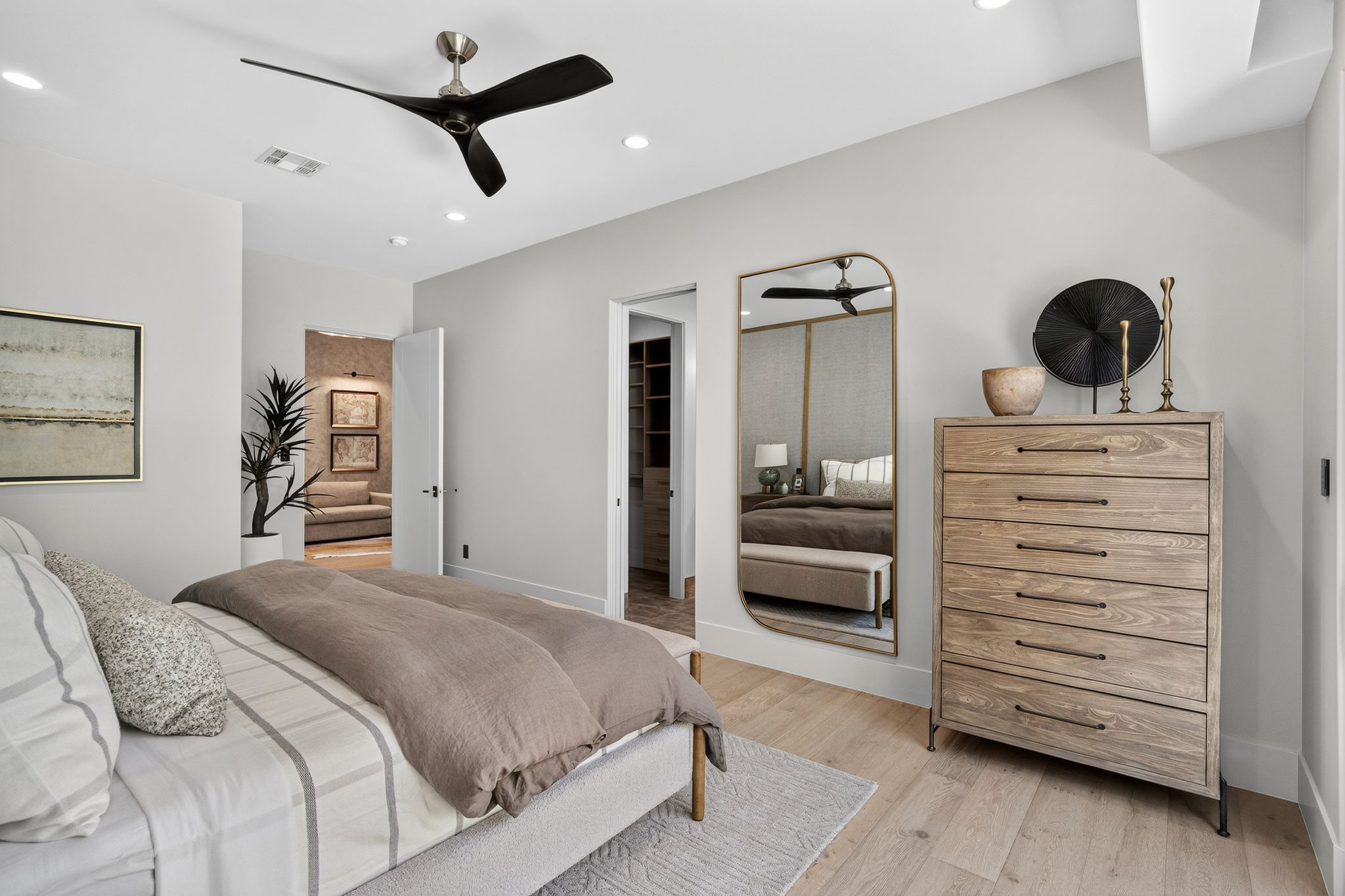Light-toned wood-finish flooring complements the neutral wall color