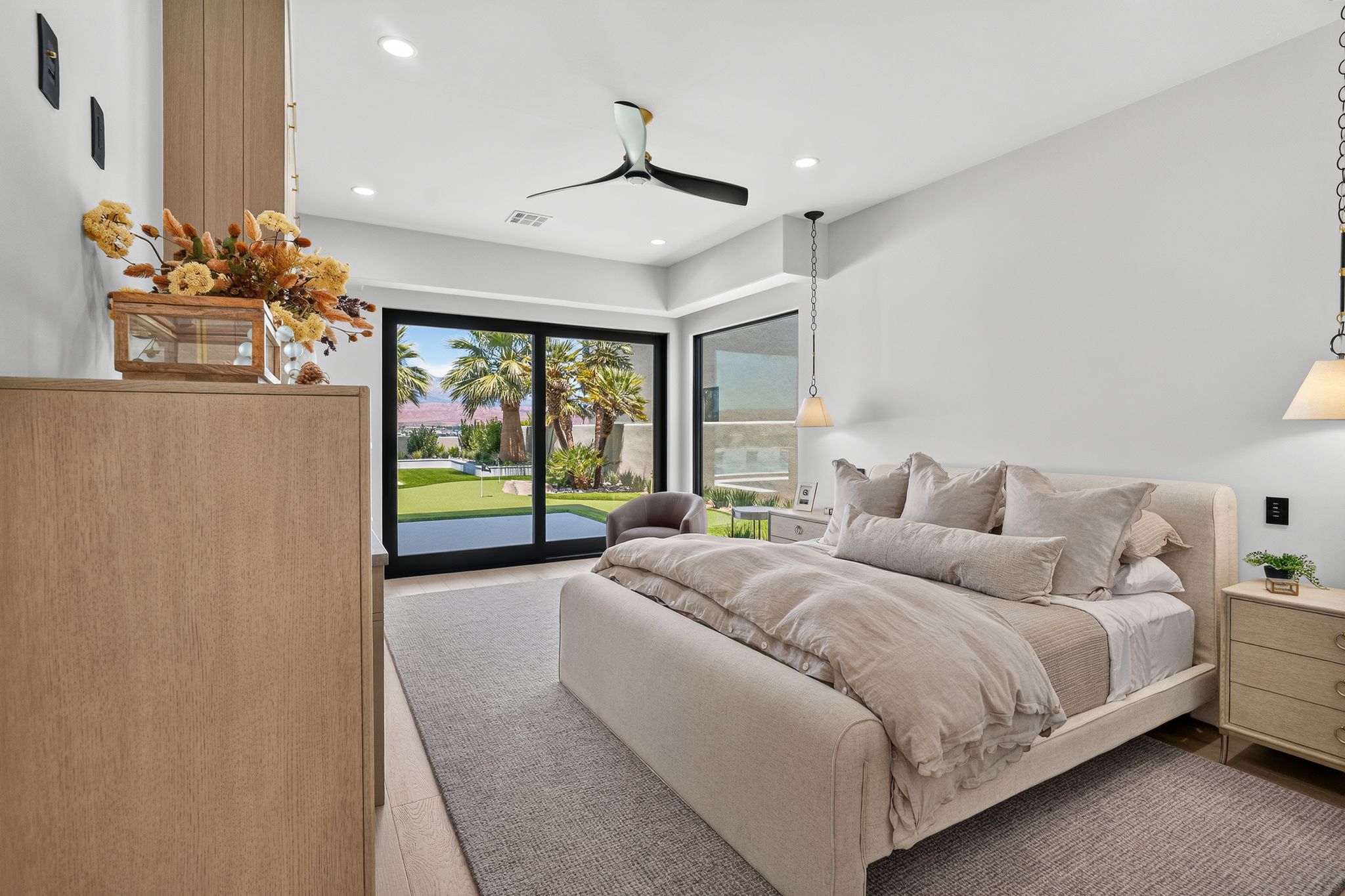 Spacious room with large sliding glass doors, white walls, and a light-colored carpet