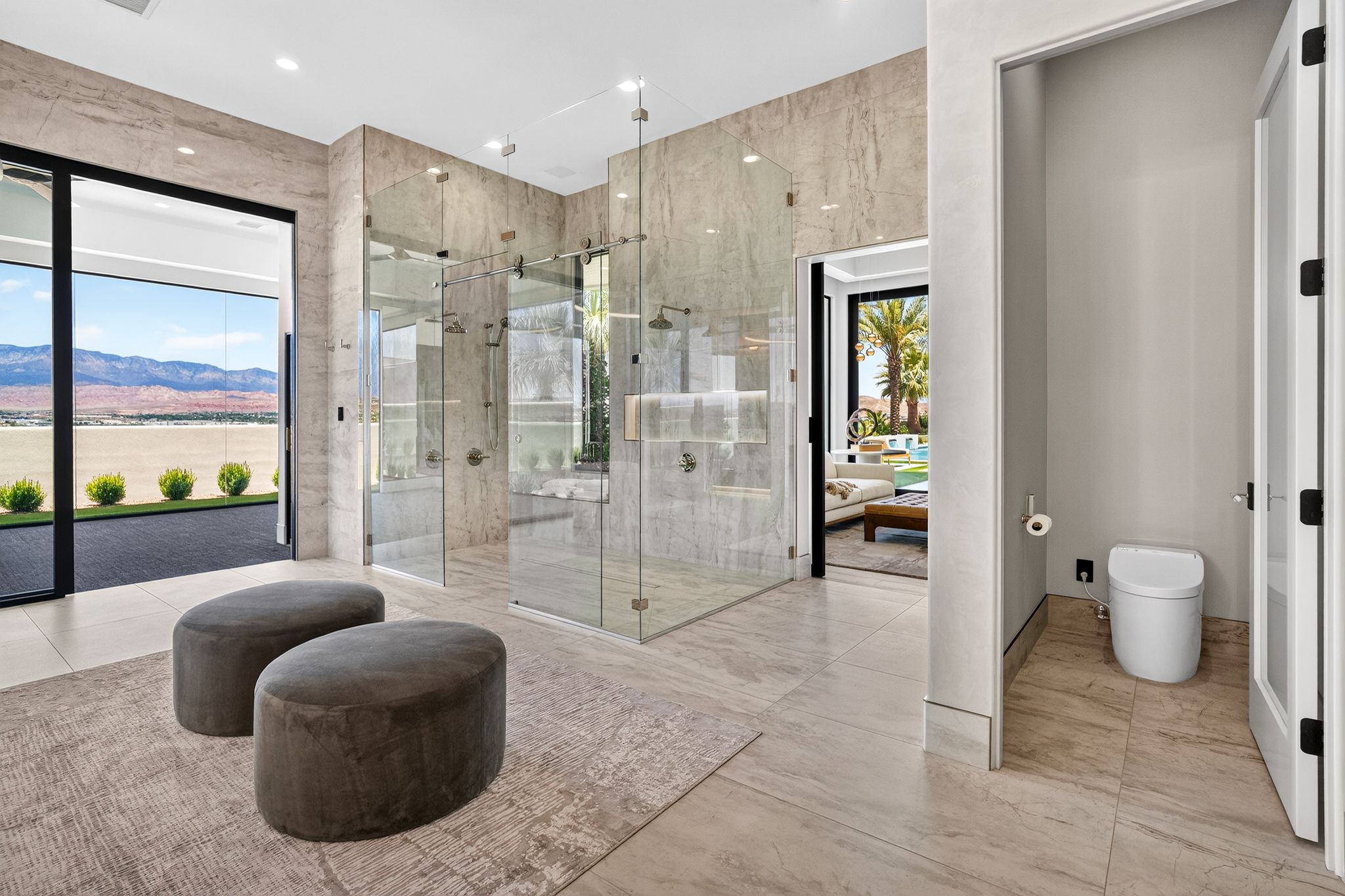 Spacious bathroom featuring large format tile flooring and wall finishes