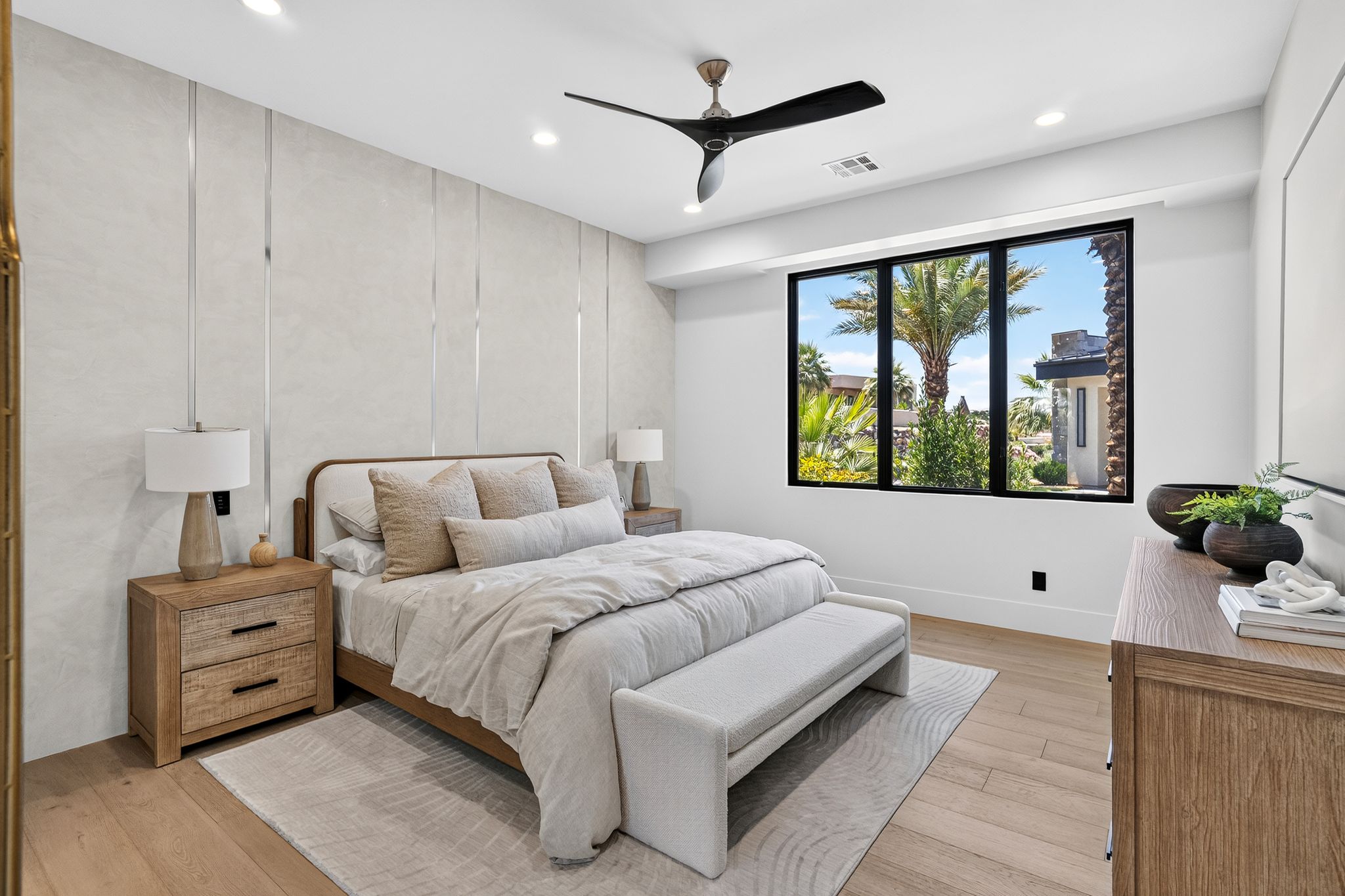 Spacious room featuring wood-finish flooring, a contemporary ceiling fan, and recessed lighting