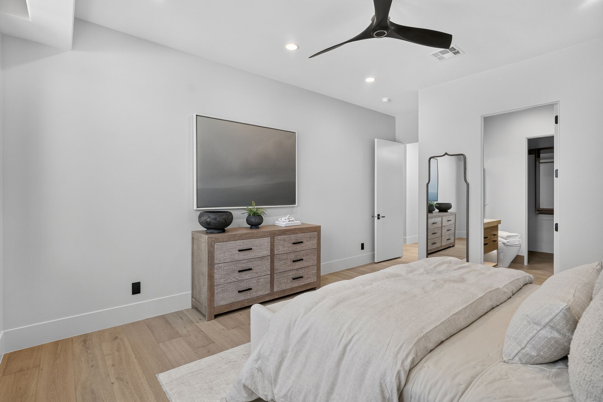 Light wood-finish flooring complements the neutral wall tones