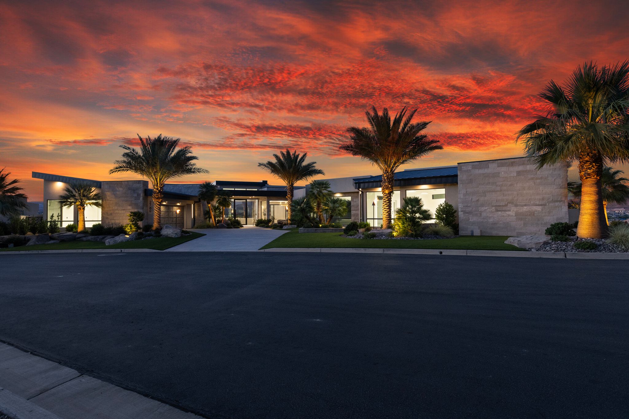 Modern single-story residence with a flat roofline and stone facade accents