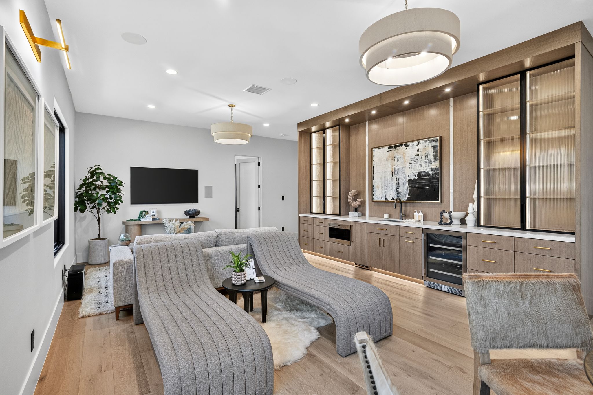 Built-in cabinetry with integrated lighting, a beverage refrigerator, and open shelving with fluted glass doors
