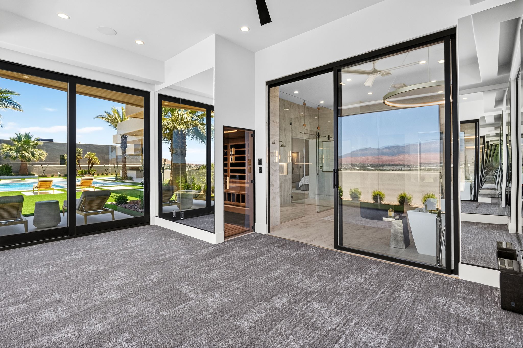 Sliding glass doors opening to an outdoor living area with a swimming pool and artificial turf
