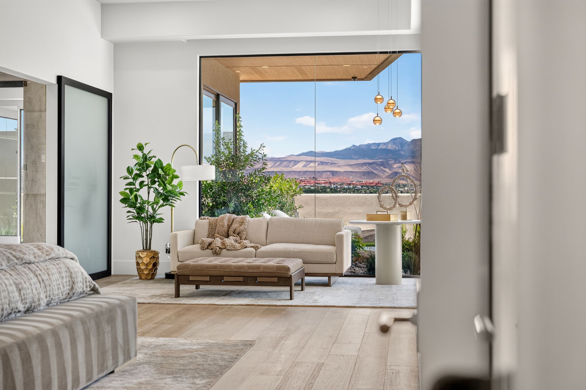 Spacious room with wood-finish flooring and a full-height glass wall