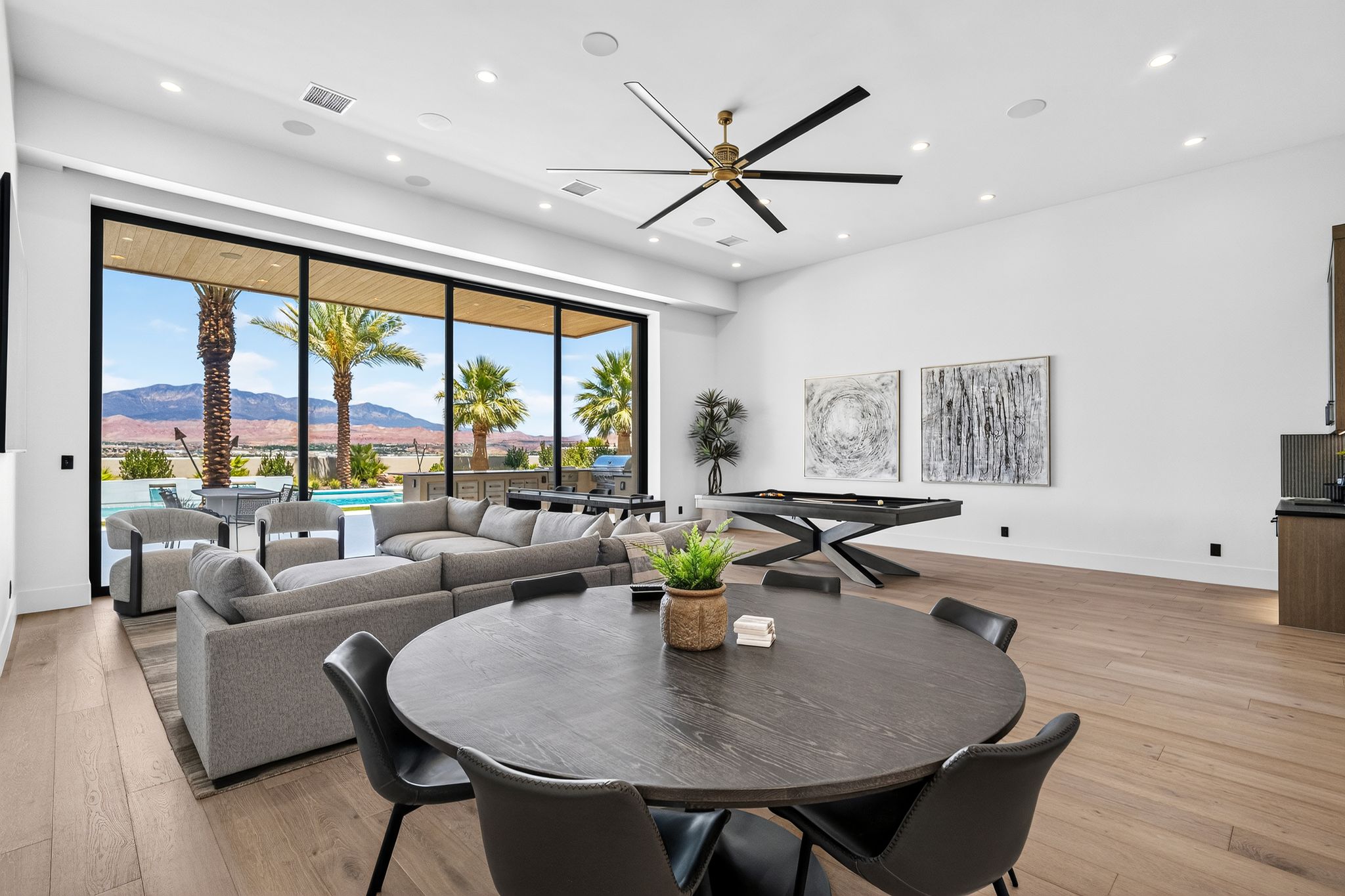 Expansive living area with wood-finish flooring and recessed lighting
