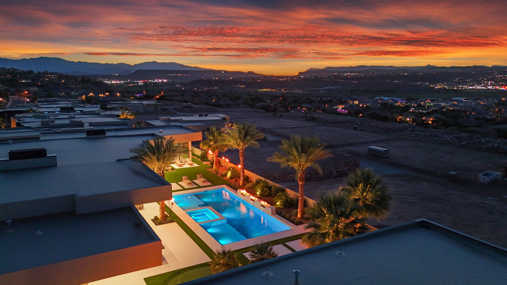 Expansive outdoor living area featuring a swimming pool, integrated spa, and manicured lawn