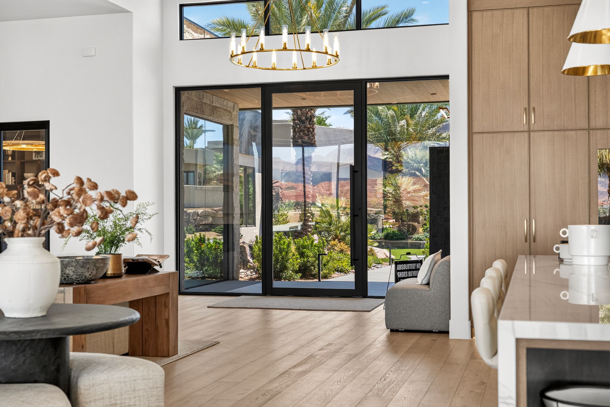 Expansive entry with wood-finish flooring and a contemporary chandelier