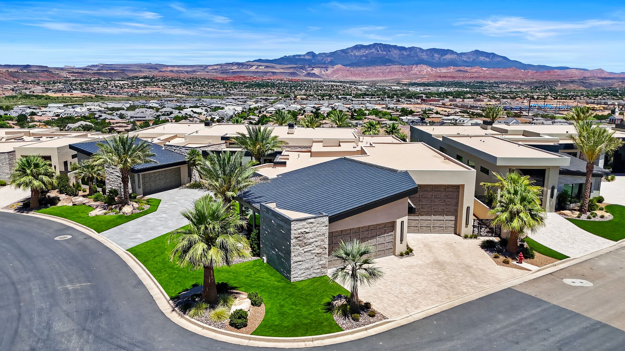 Modern exterior featuring a dark metal roof and light stone accents