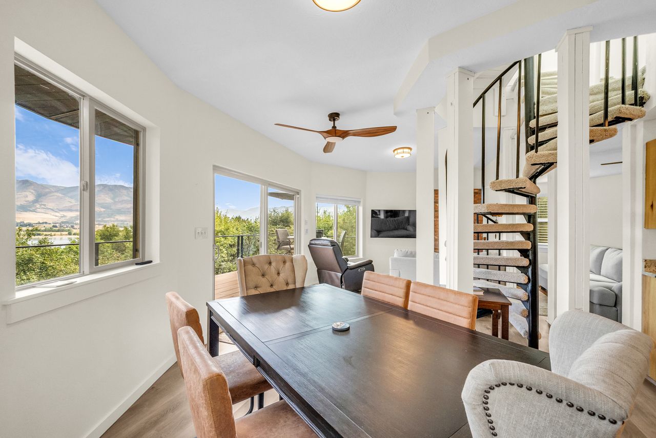 Open-concept interior featuring light wood-finish flooring and a white color palette