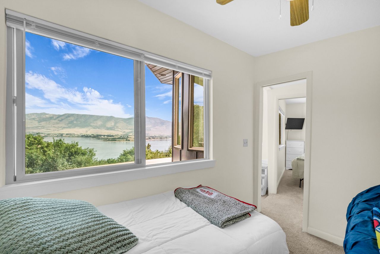 Large window framing a serene lake and distant mountains