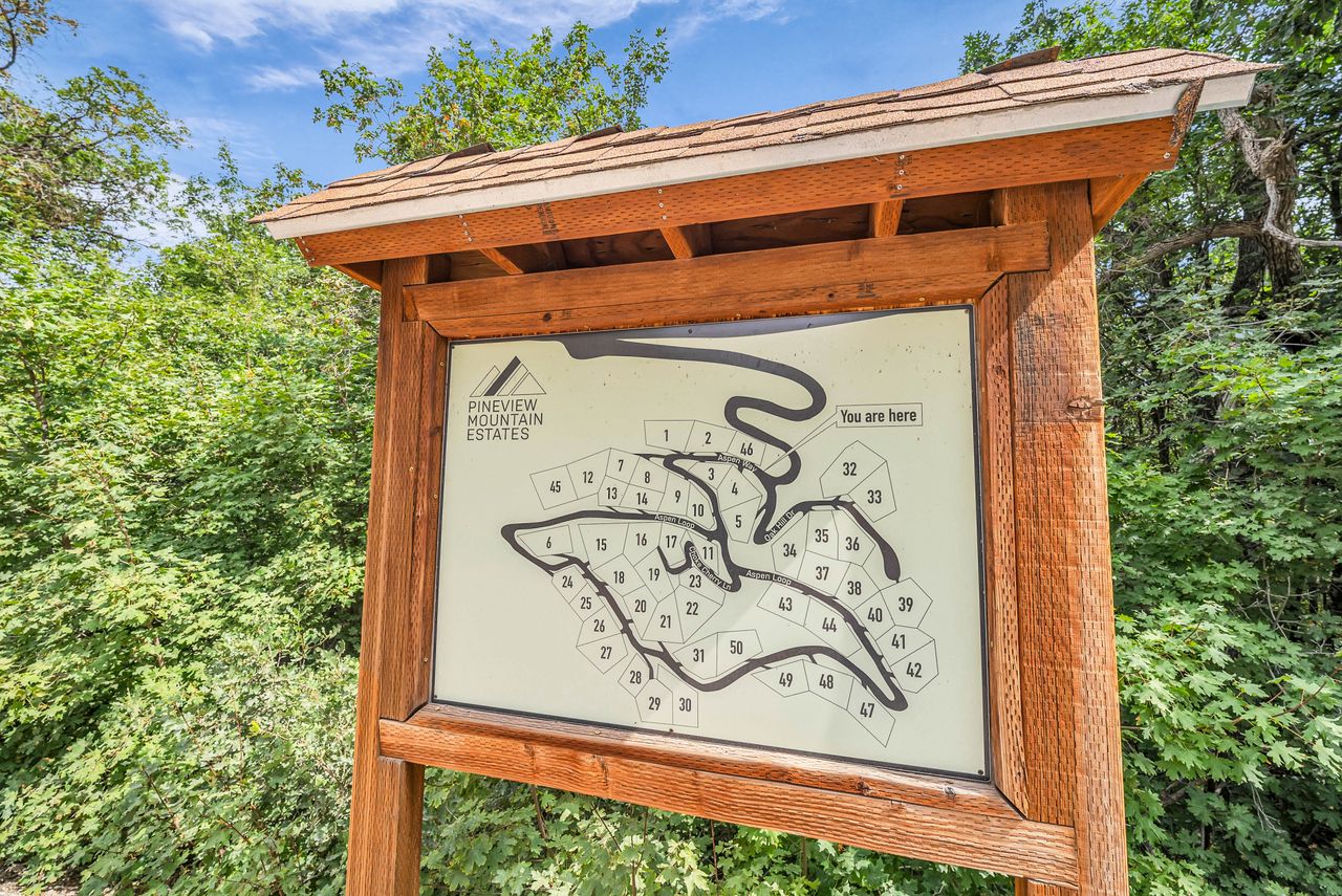 Hardwood informational kiosk with a shingle roof and a detailed community map