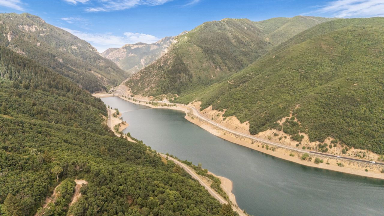 Expansive body of water bordered by mountainous terrain