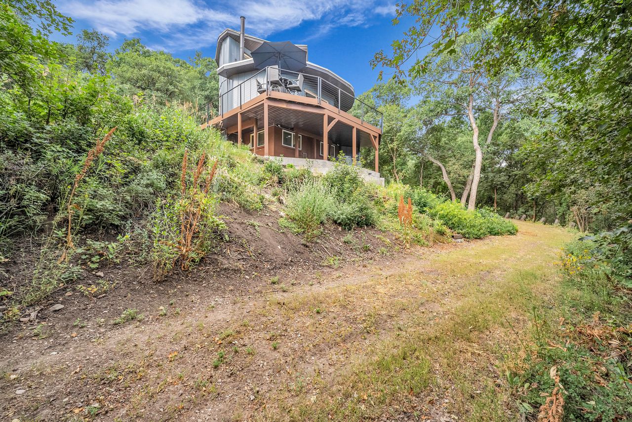 Architectural residence situated on a sloped, wooded lot