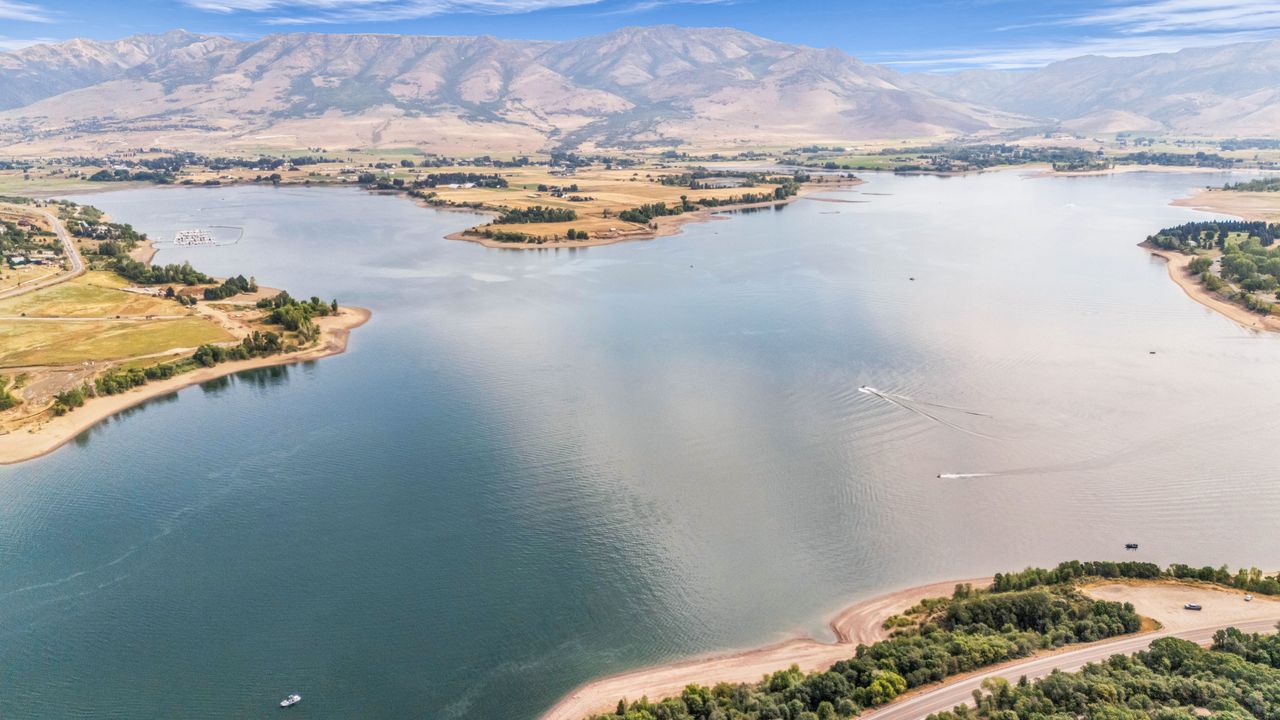 Expansive waterfront property bordered by mountainous terrain