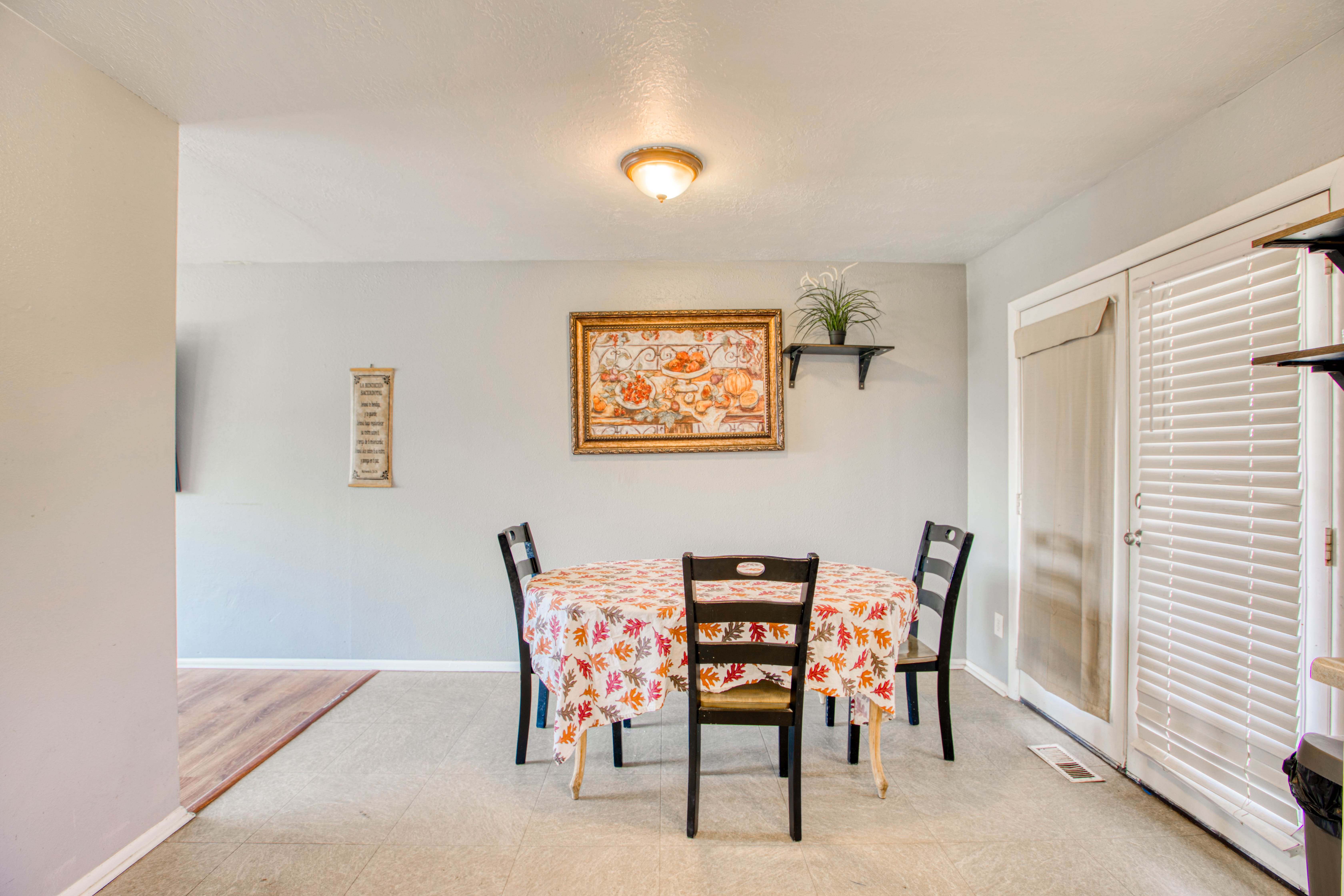 Dining area featuring light-toned flooring, neutral wall paint, and a ceiling-mounted light fixture