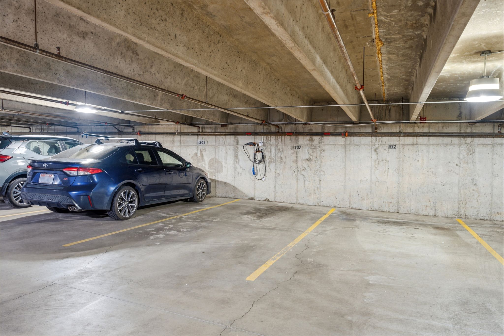 Dedicated parking space with personal electric vehicle charging station