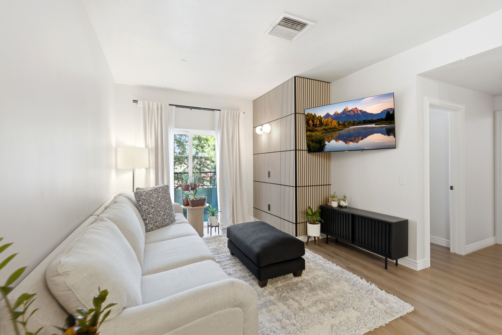 Living room with accent wall and natural light.