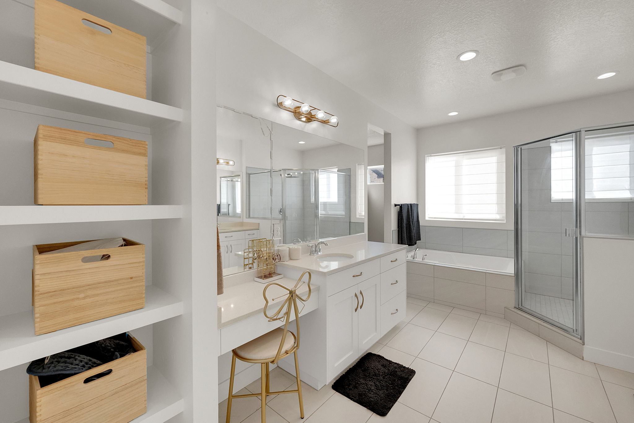 Spacious bathroom featuring white cabinetry, a built-in vanity, a soaking tub, a glass-enclosed shower, and recessed lighting