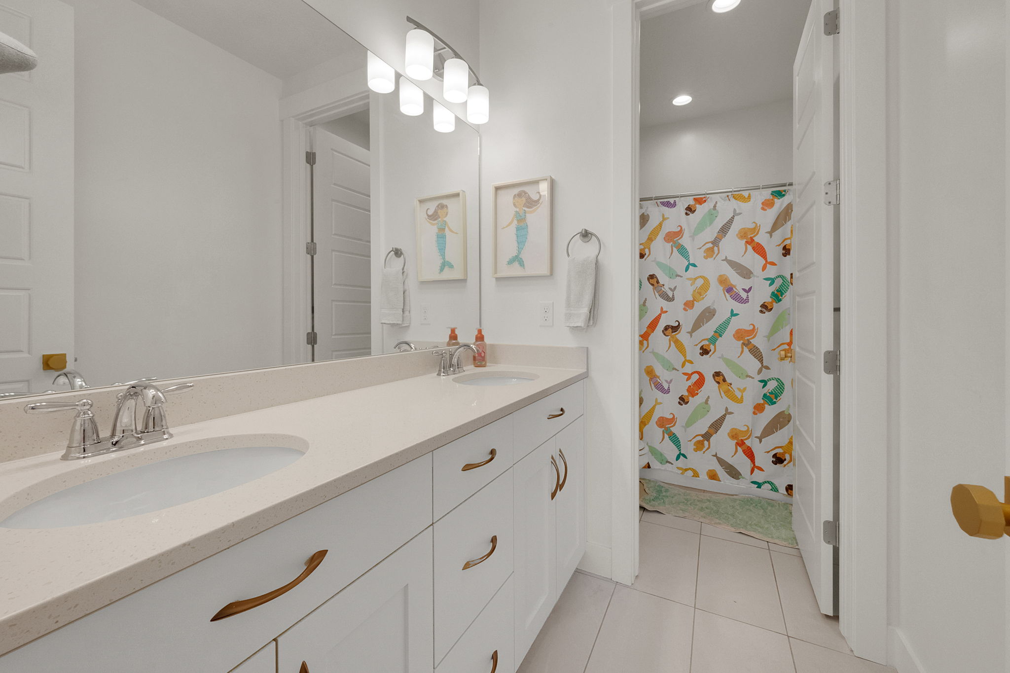 Double vanity with integrated sinks, light-toned countertop, and chrome faucets