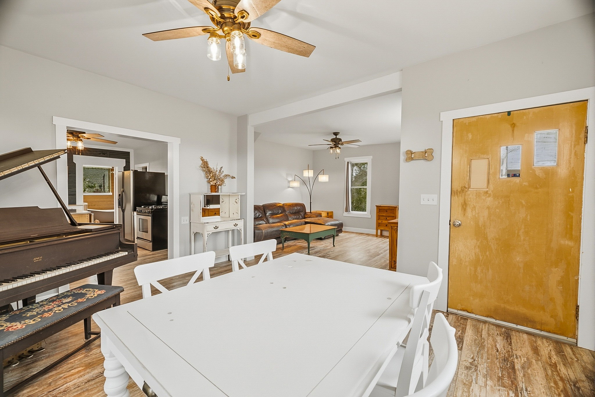 Open-concept interior featuring wood-finish flooring, light gray walls, and recessed archways