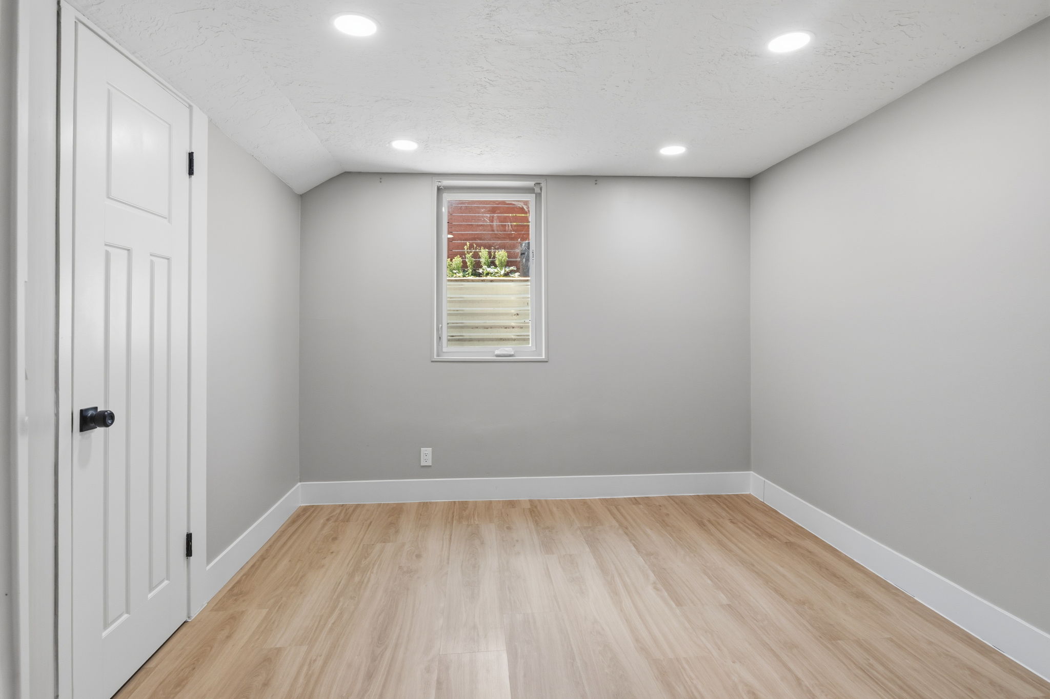 Interior room featuring wood-finish flooring and light gray painted walls