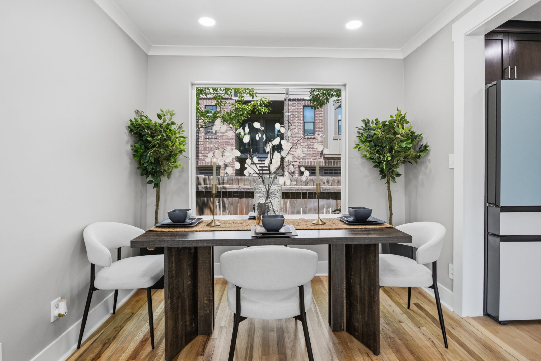 Dedicated dining area featuring wood-finish flooring, recessed lighting, and a large window