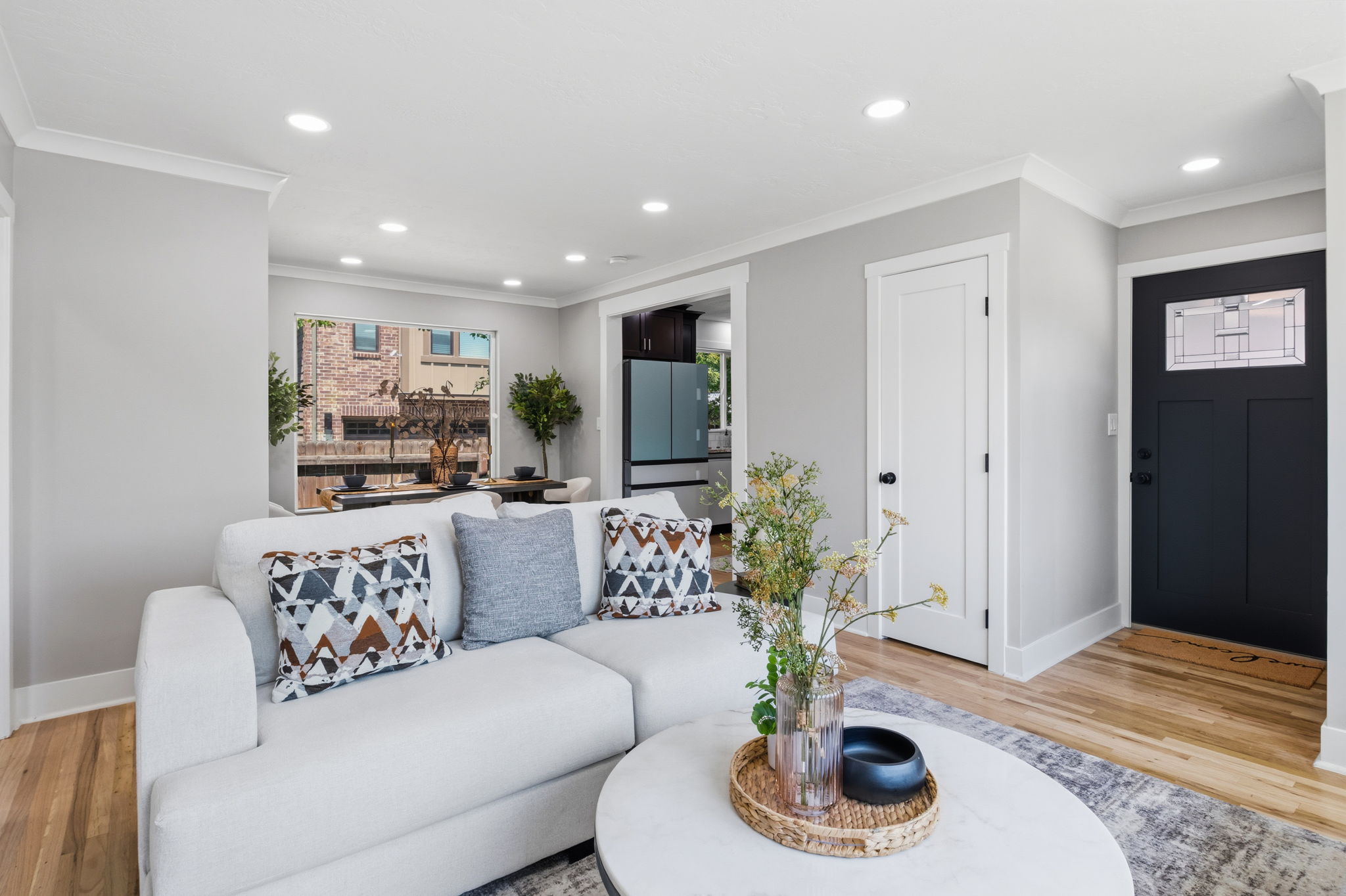 Bright living space featuring recessed lighting and crown molding
