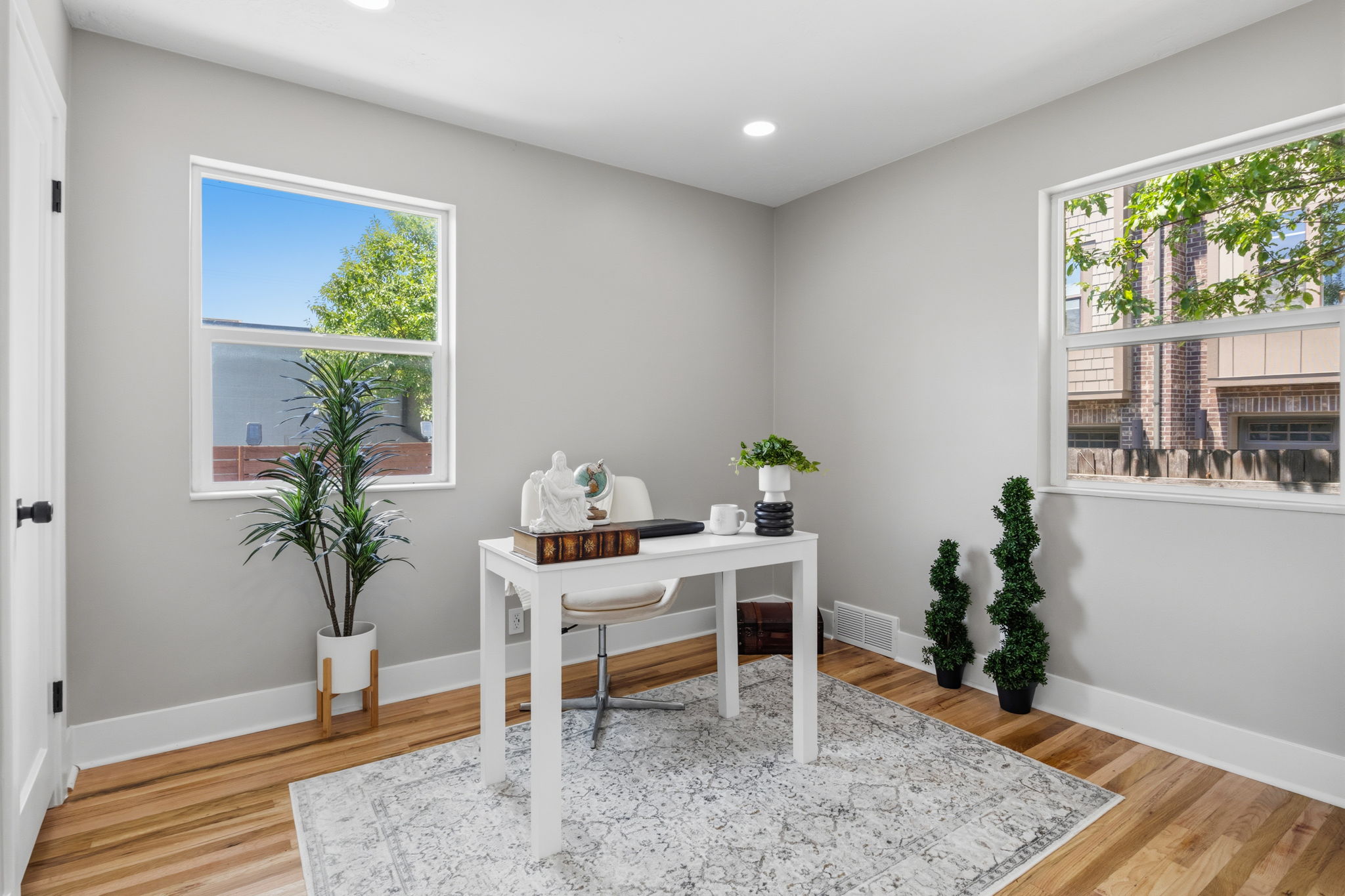 Neutral wall tones complement the wood-finish flooring in this room