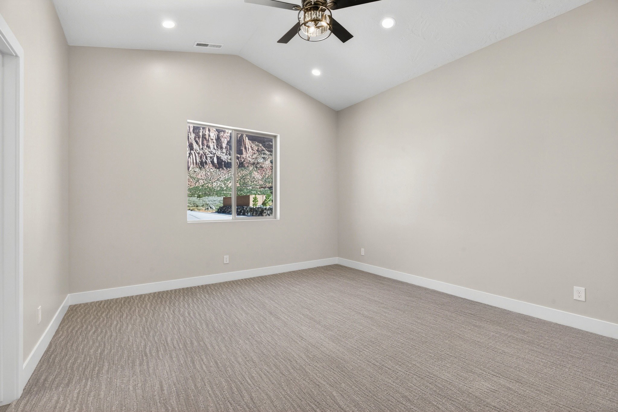 Vaulted ceiling with recessed lighting and a ceiling fan