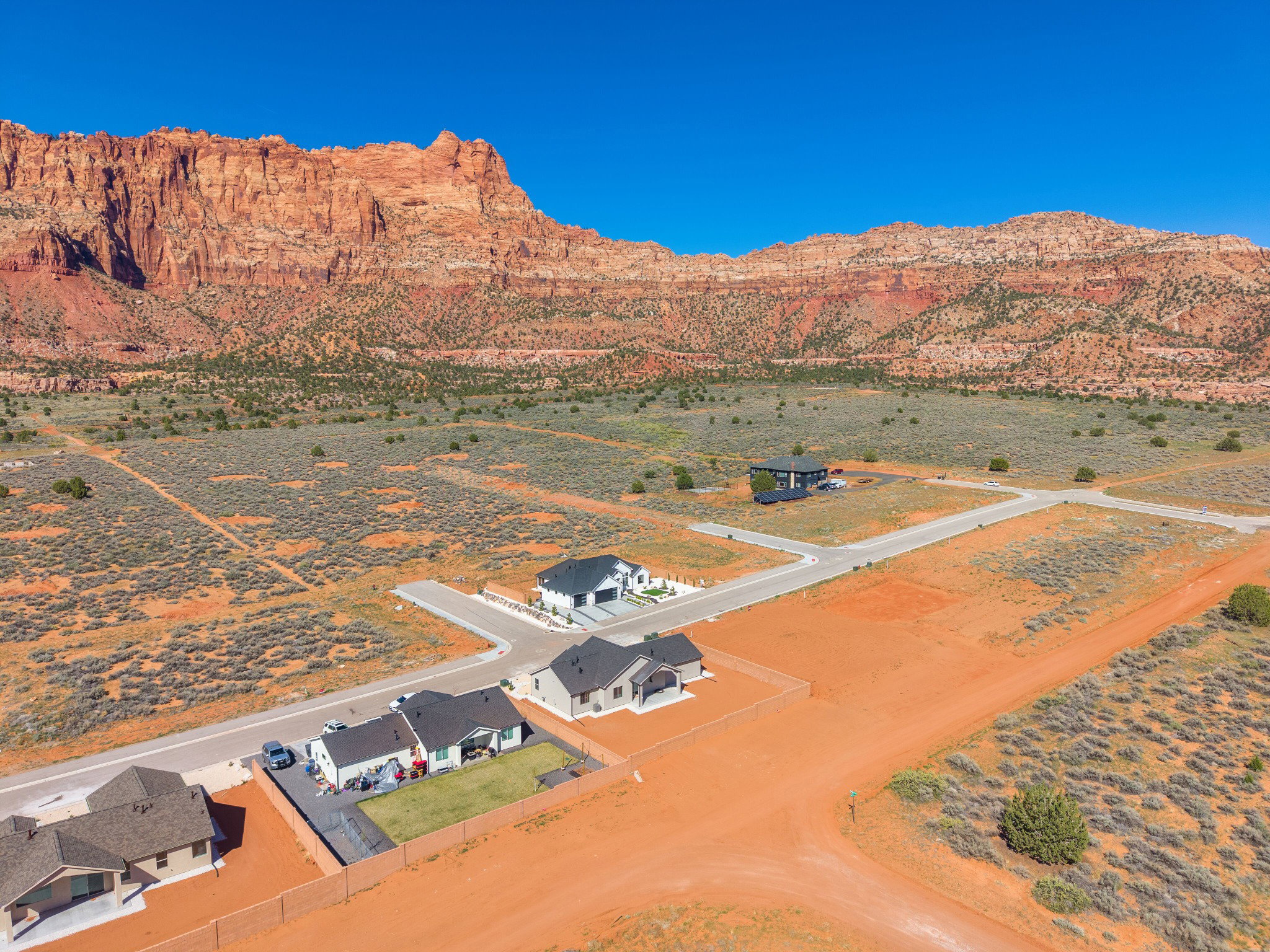 Expansive desert landscape featuring red rock mountain formations