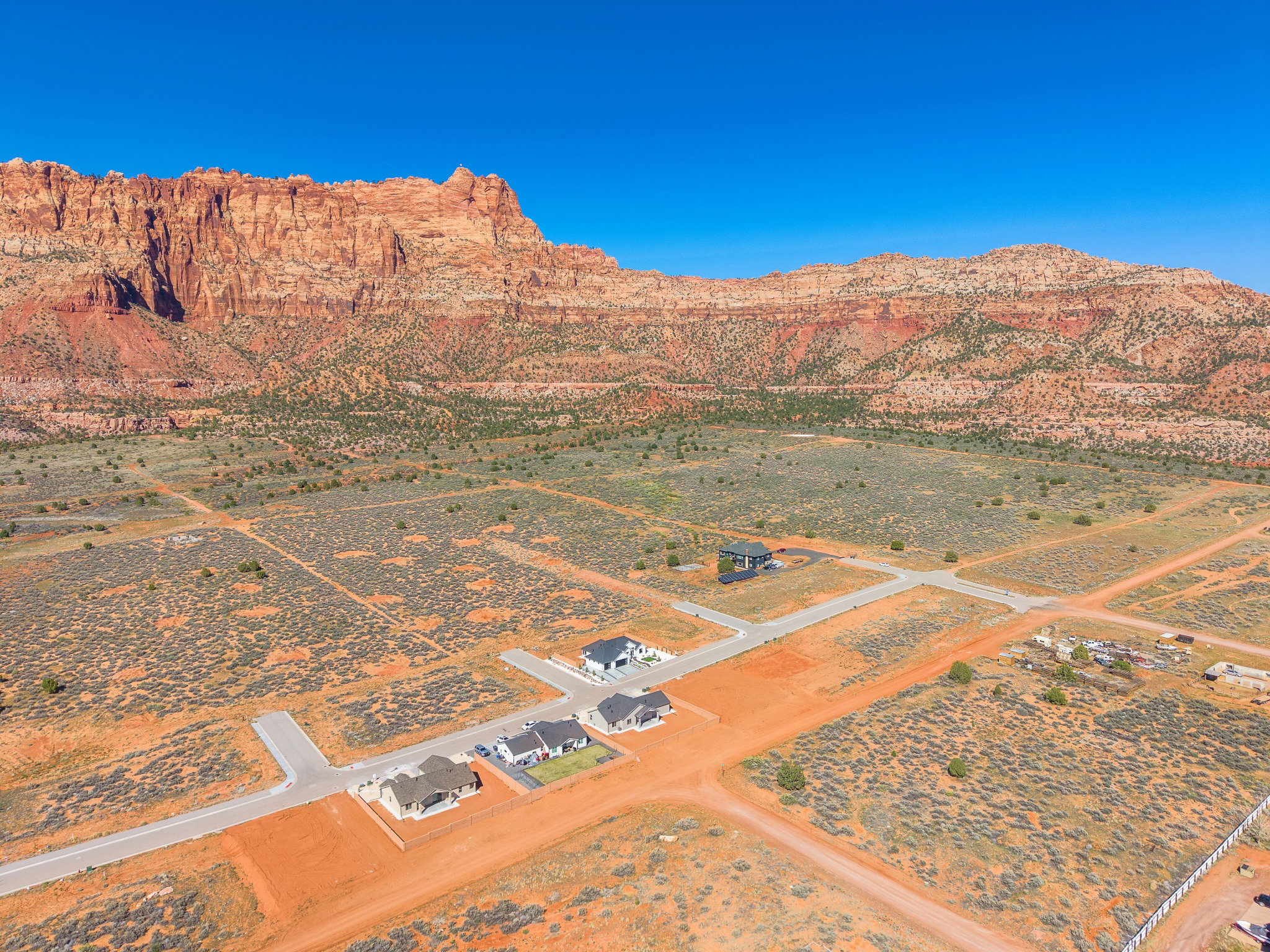 Expansive desert landscape featuring red rock mountain formations