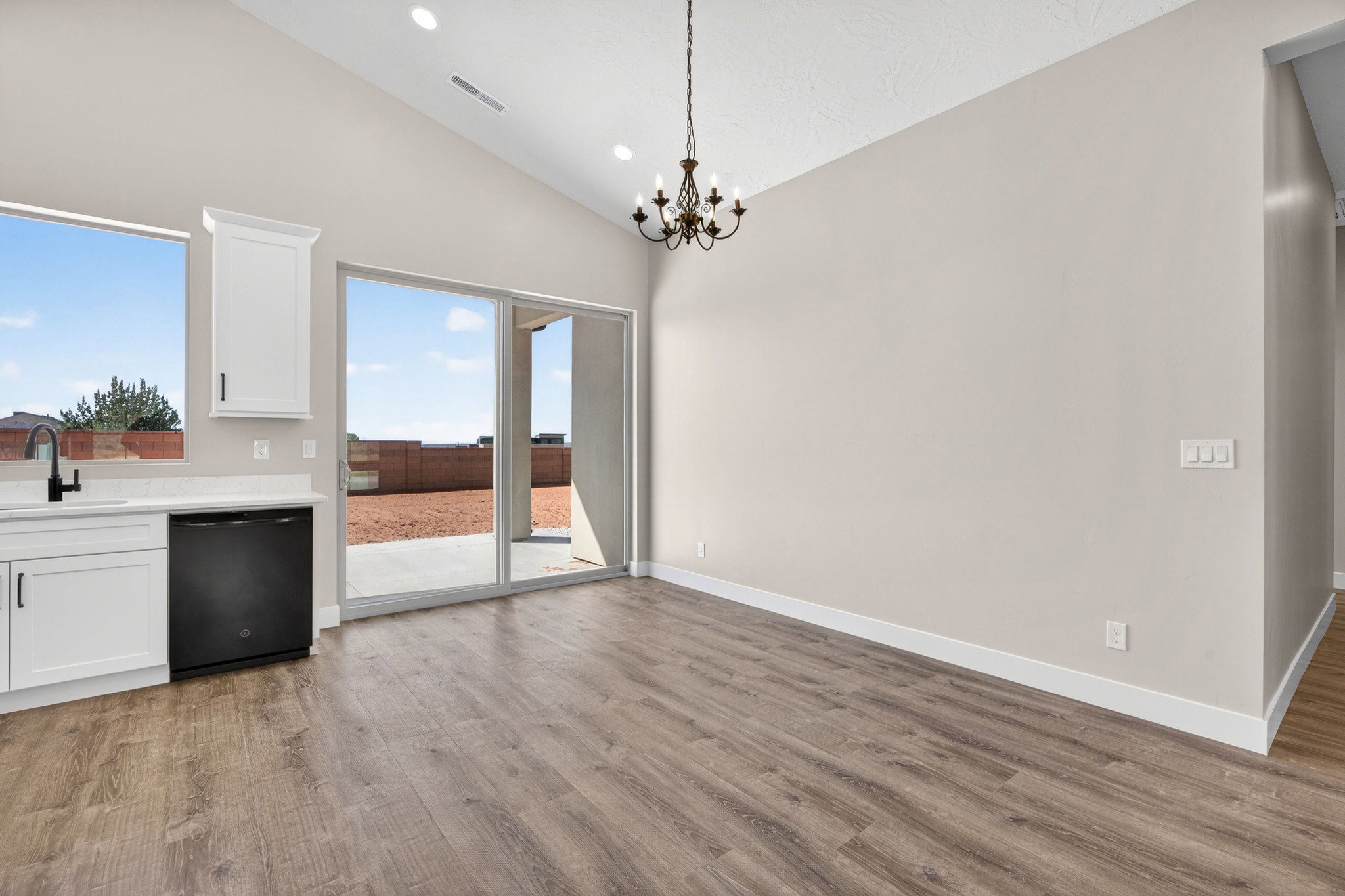 Open concept interior featuring vaulted ceilings and recessed lighting