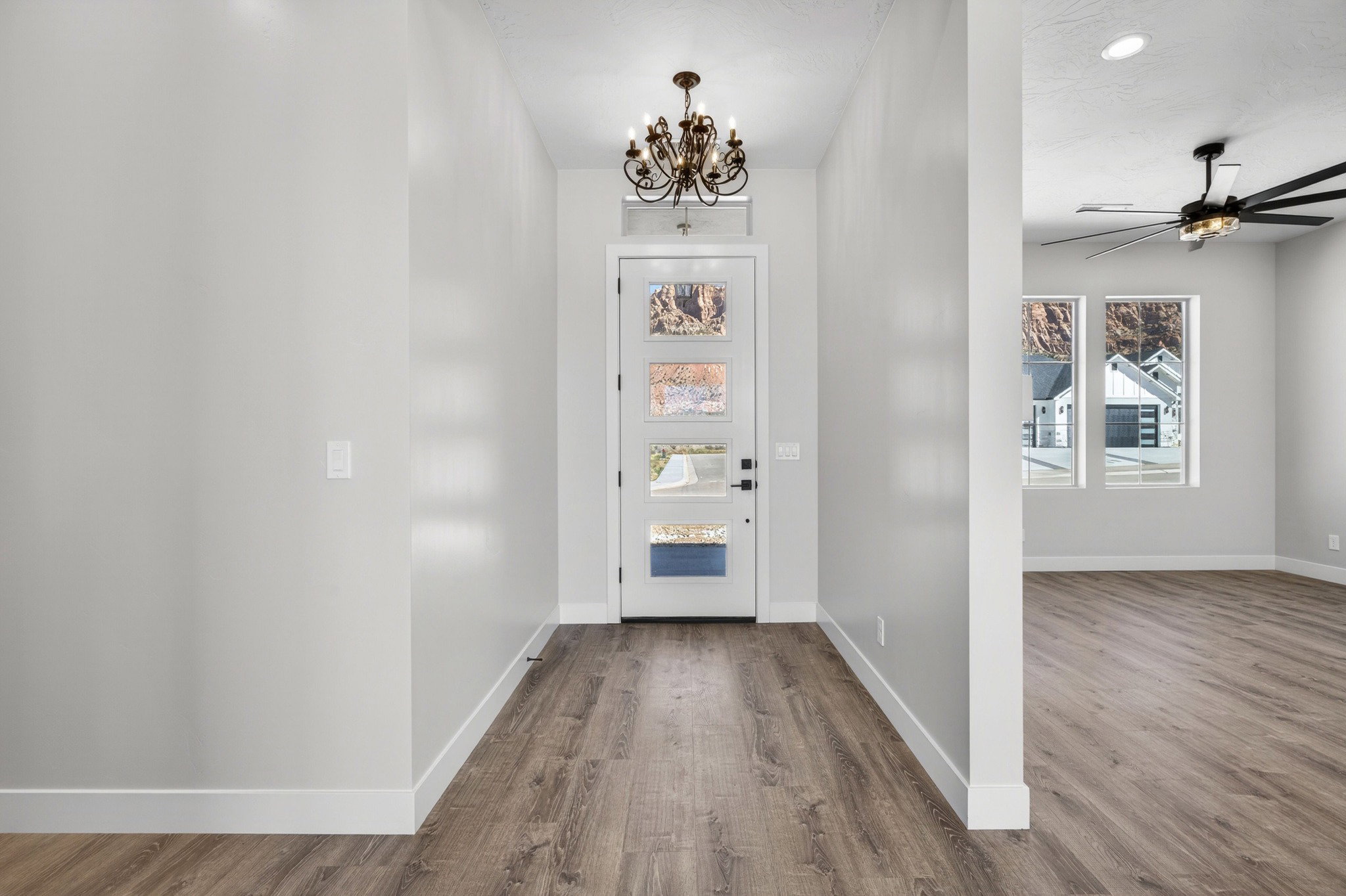 Entryway with wood-finish flooring and a decorative chandelier