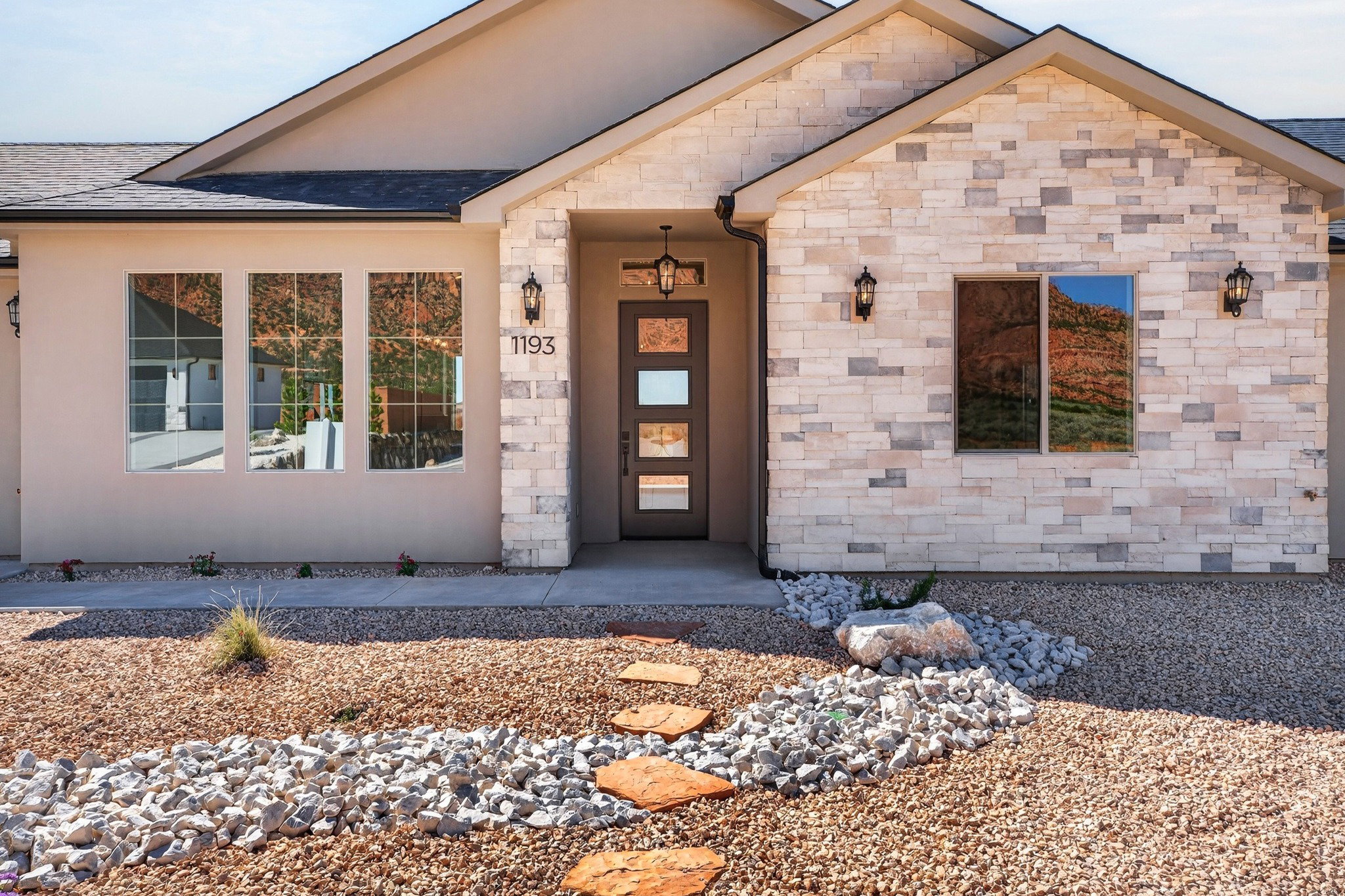 Modern desert landscape featuring a stone and stucco exterior