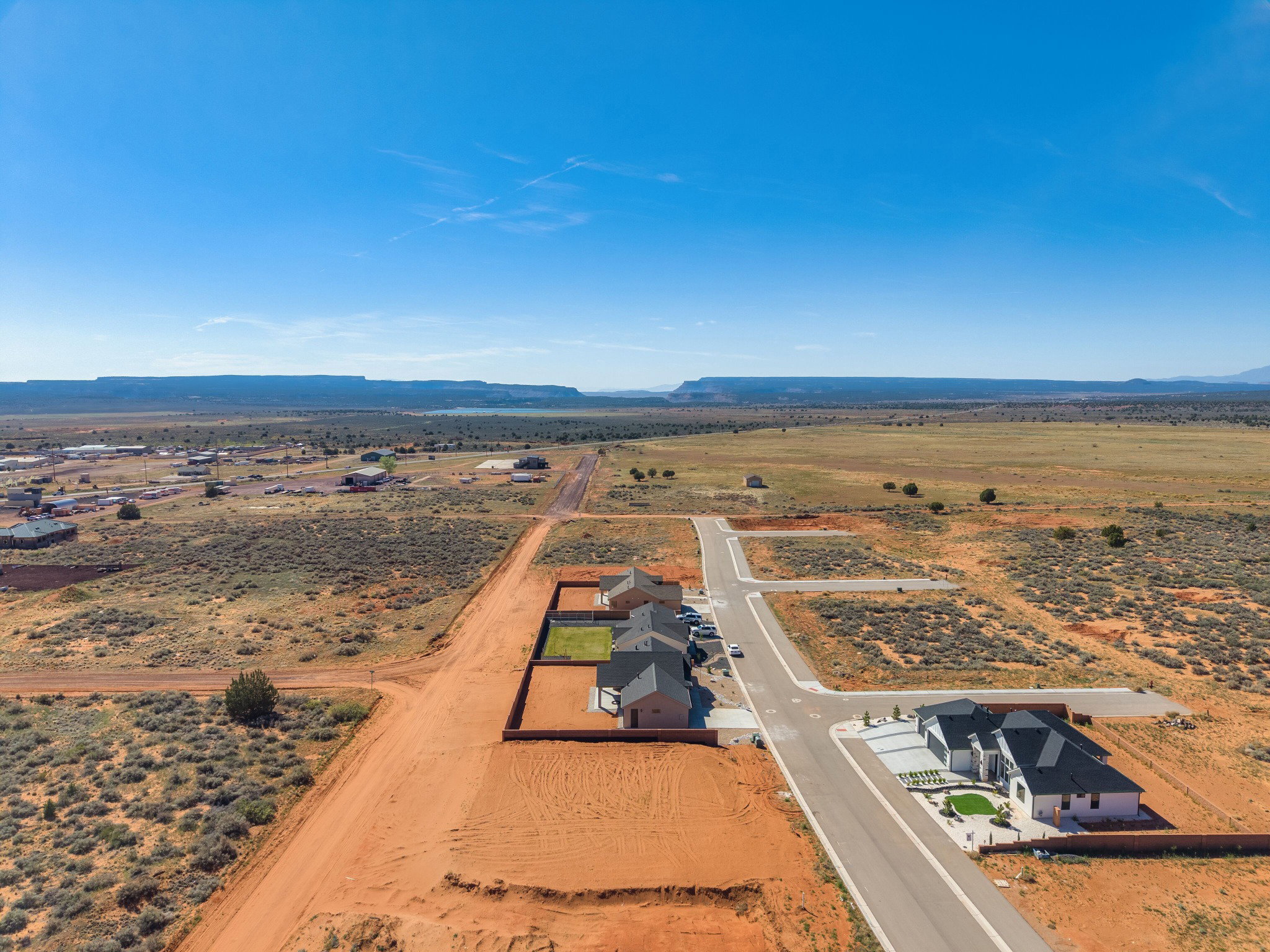 Aerial perspective showcasing a developing residential area with paved streets and established homes