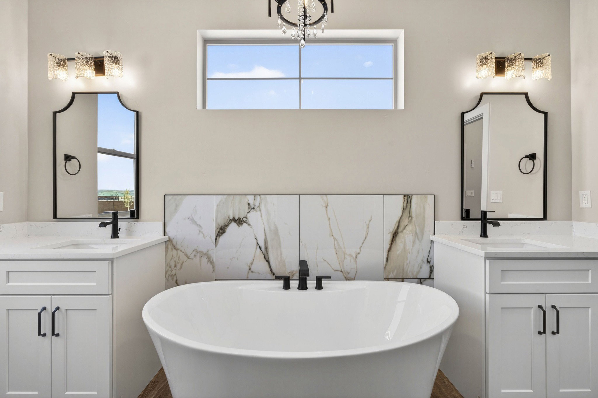Freestanding soaking tub with a striking tile accent wall