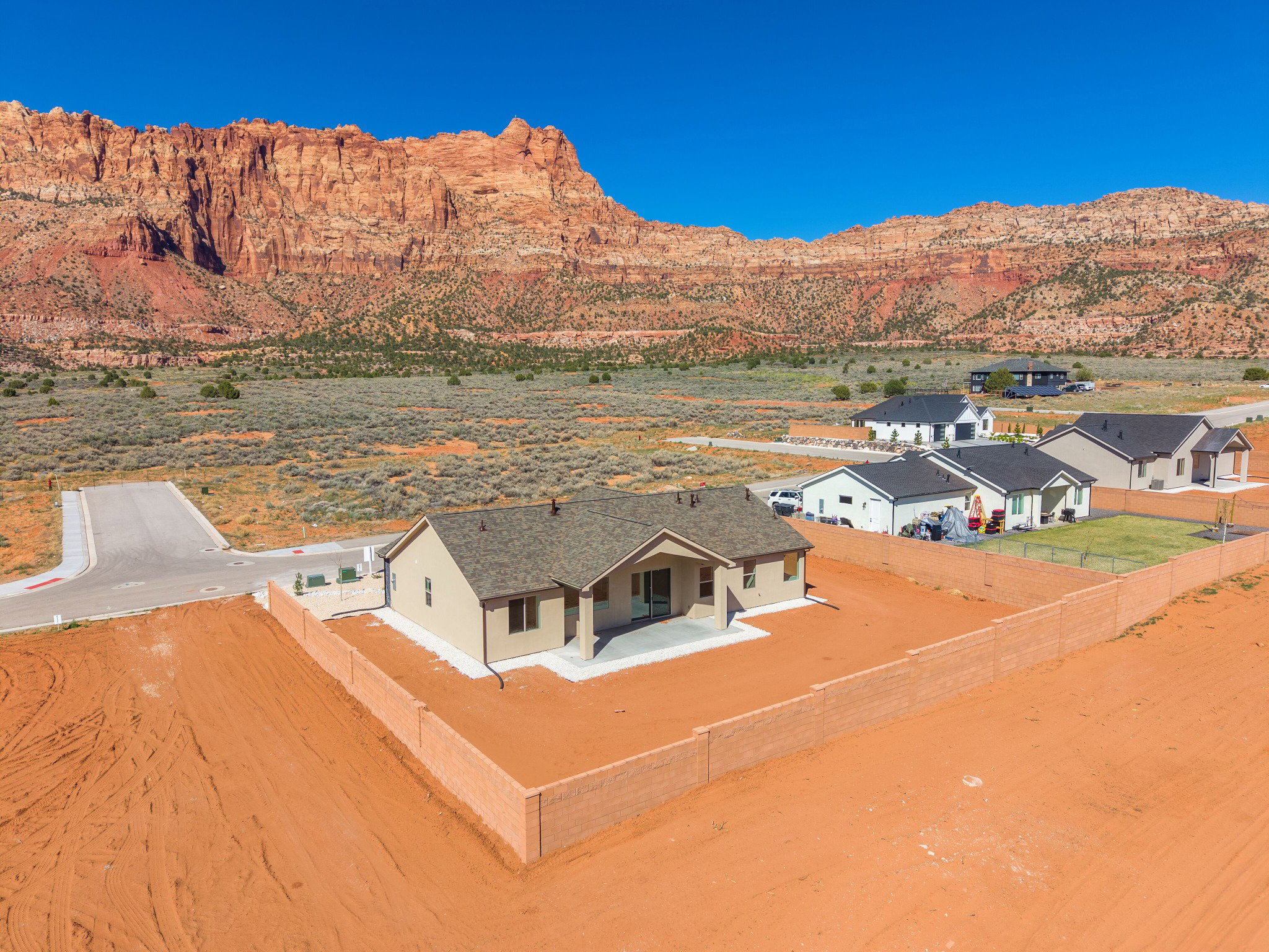 New construction residence with an expansive red rock mountain backdrop