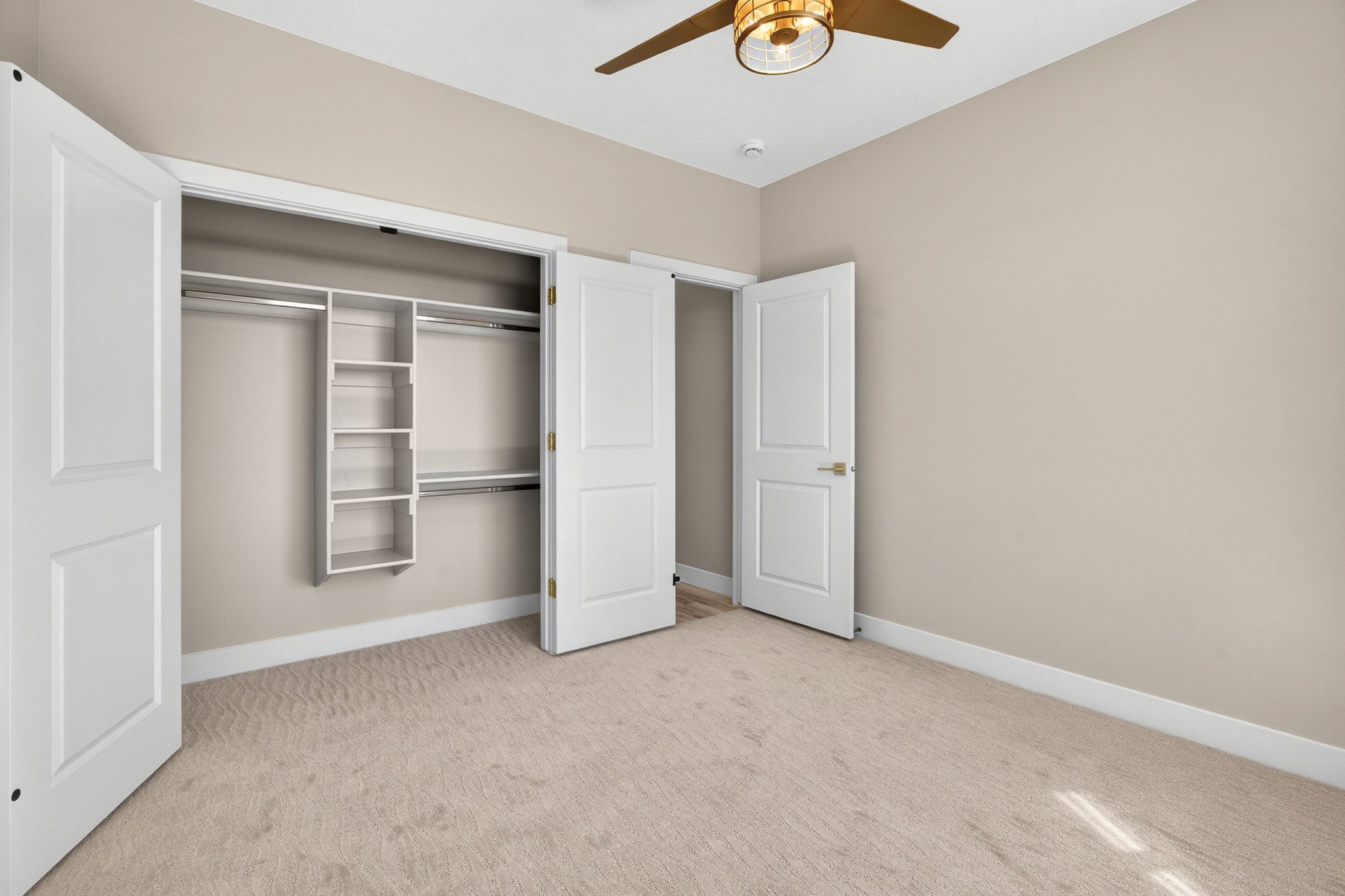 Room featuring light-toned carpeting, neutral wall color, and white baseboards