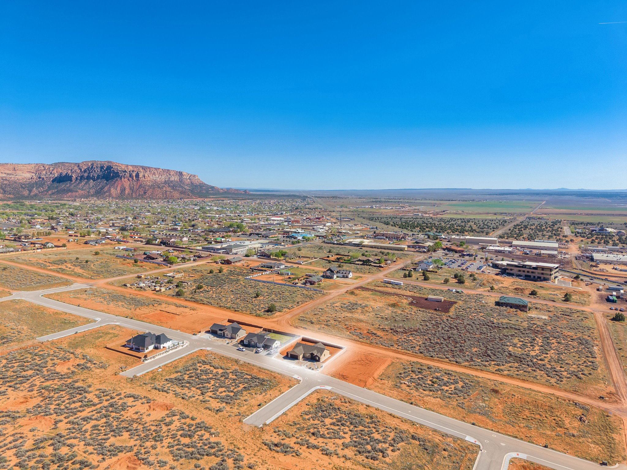 Aerial perspective showcasing residential properties and undeveloped land