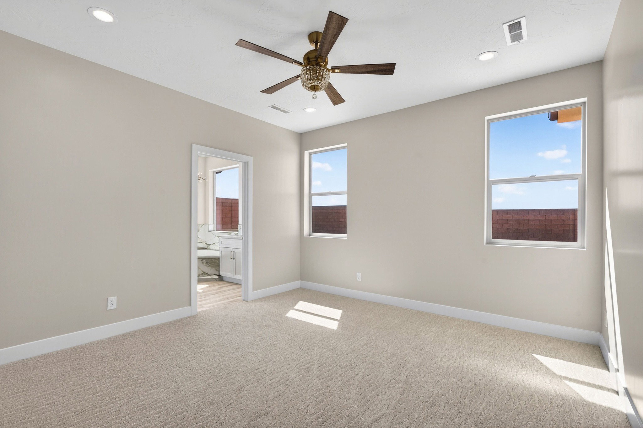 Carpeted room with recessed lighting and a ceiling fan