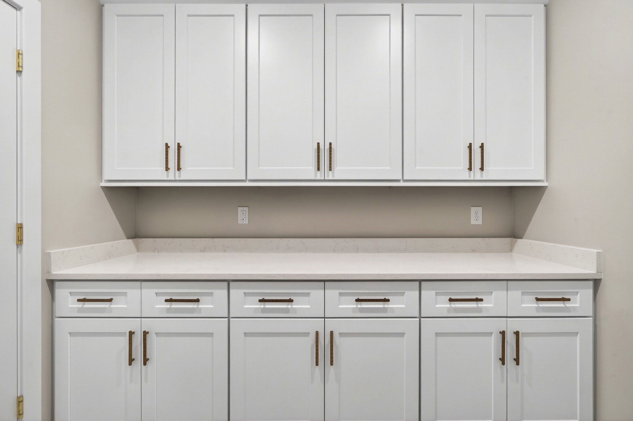 White cabinetry featuring Shaker-style doors and bronze hardware
