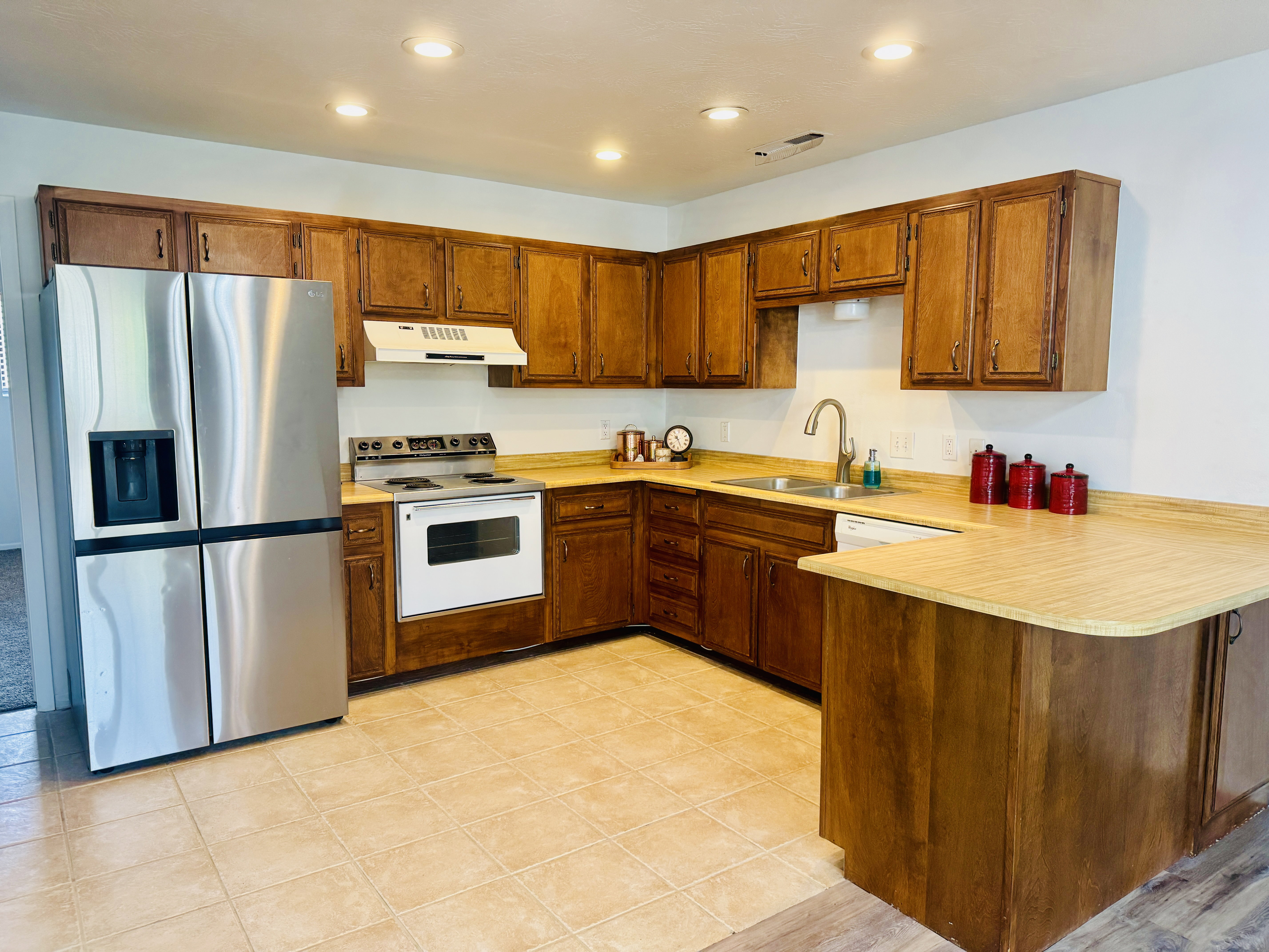 Kitchen featuring warm wood cabinetry, light wood-finish countertops, and recessed ceiling lighting