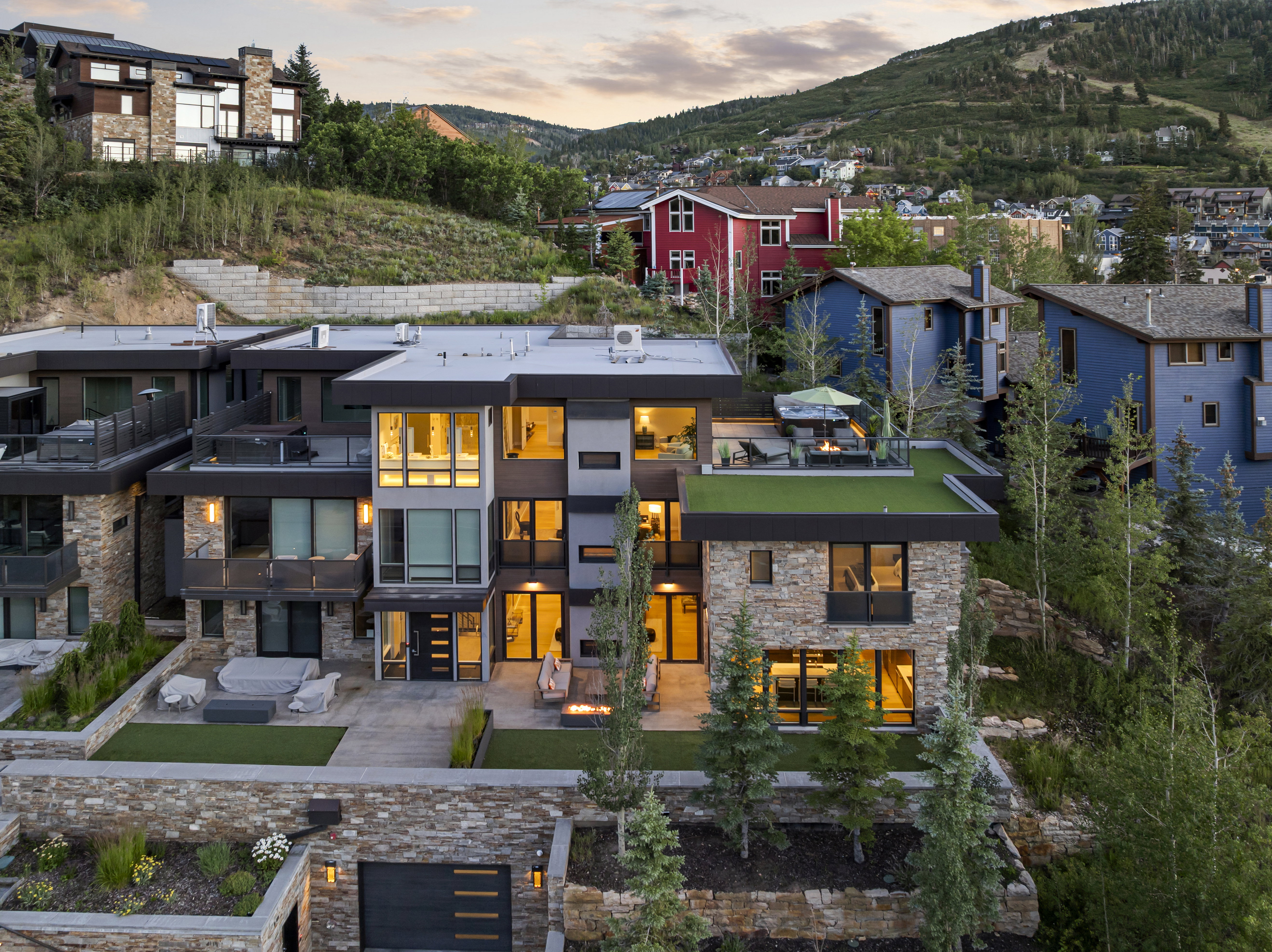 Multi-level modern residence featuring stone and dark paneling exterior